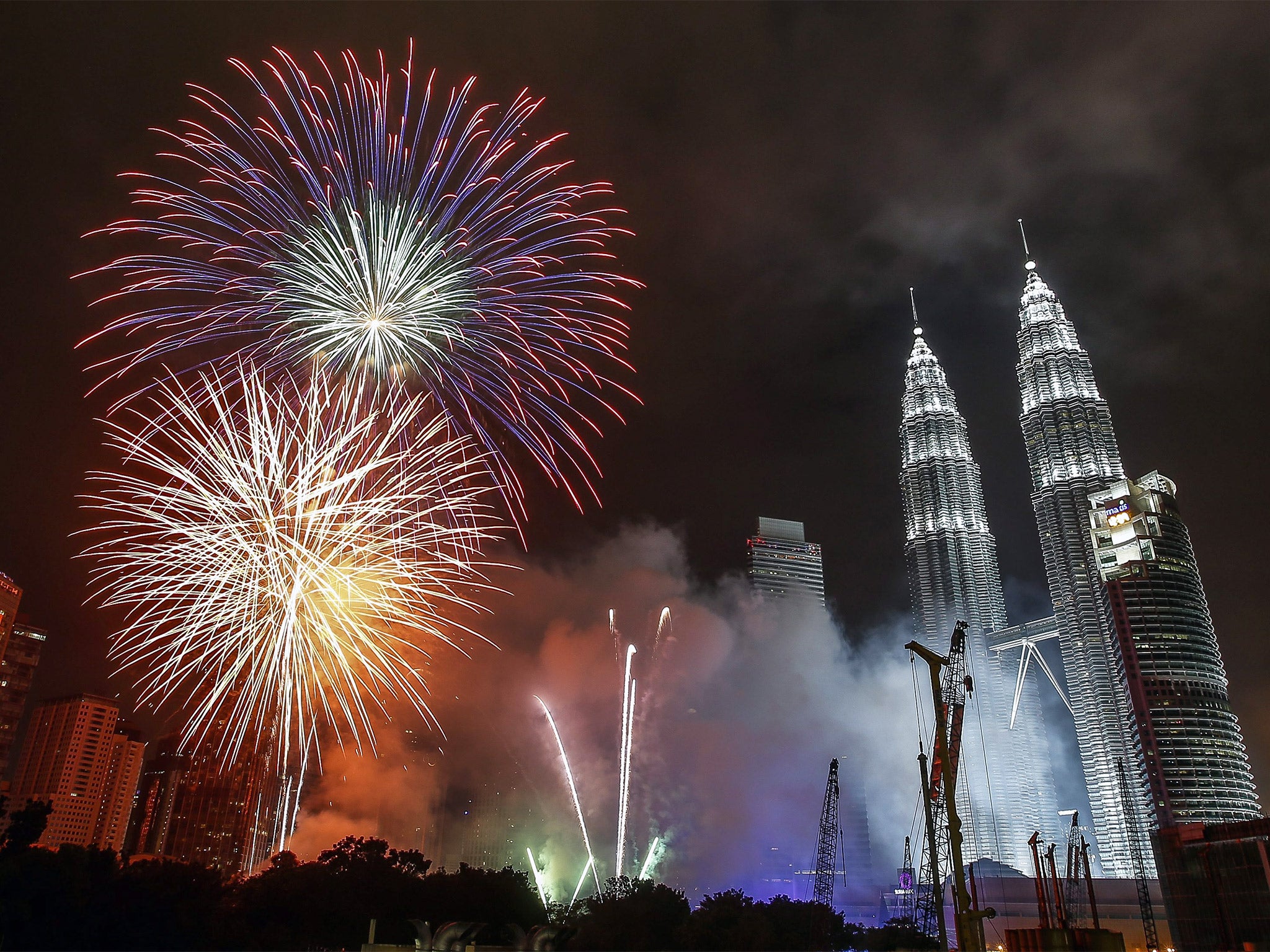 Fireworks explode near Kuala Lumpur's landmark Petronas Towers