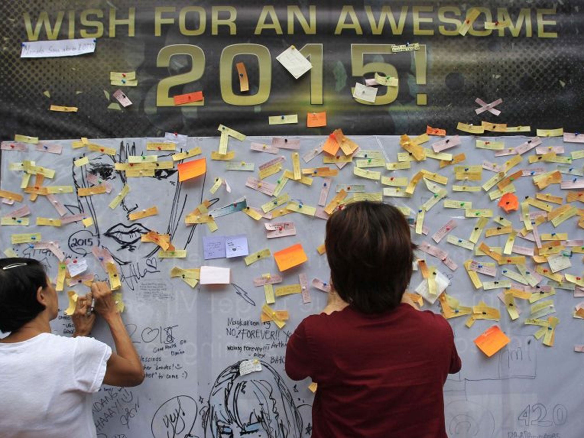 In the Philippines, people have been writing their wishes for 2015 on a wall in Quezon city, metro Manila.