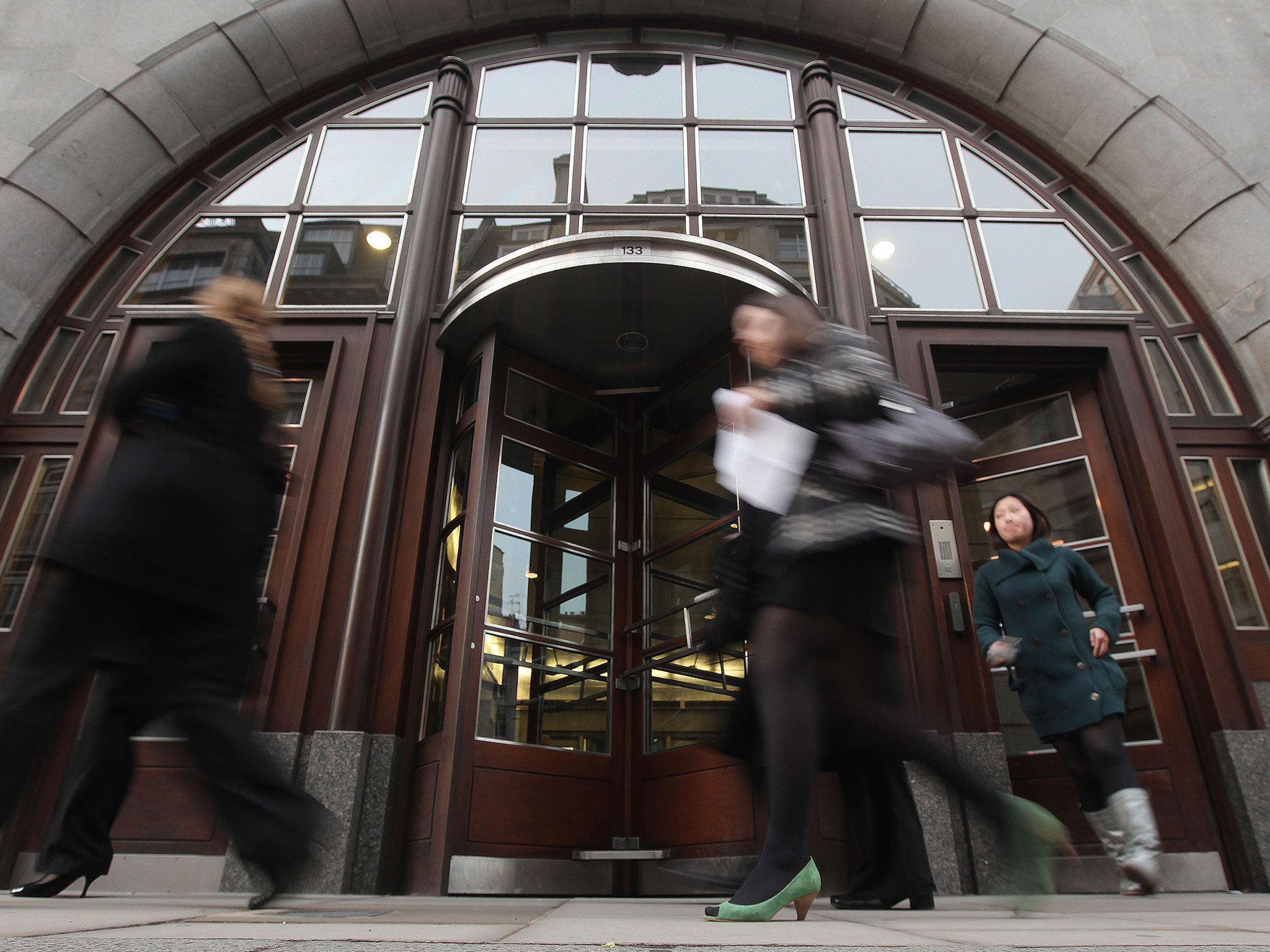 People leave the Goldman Sachs building in central London