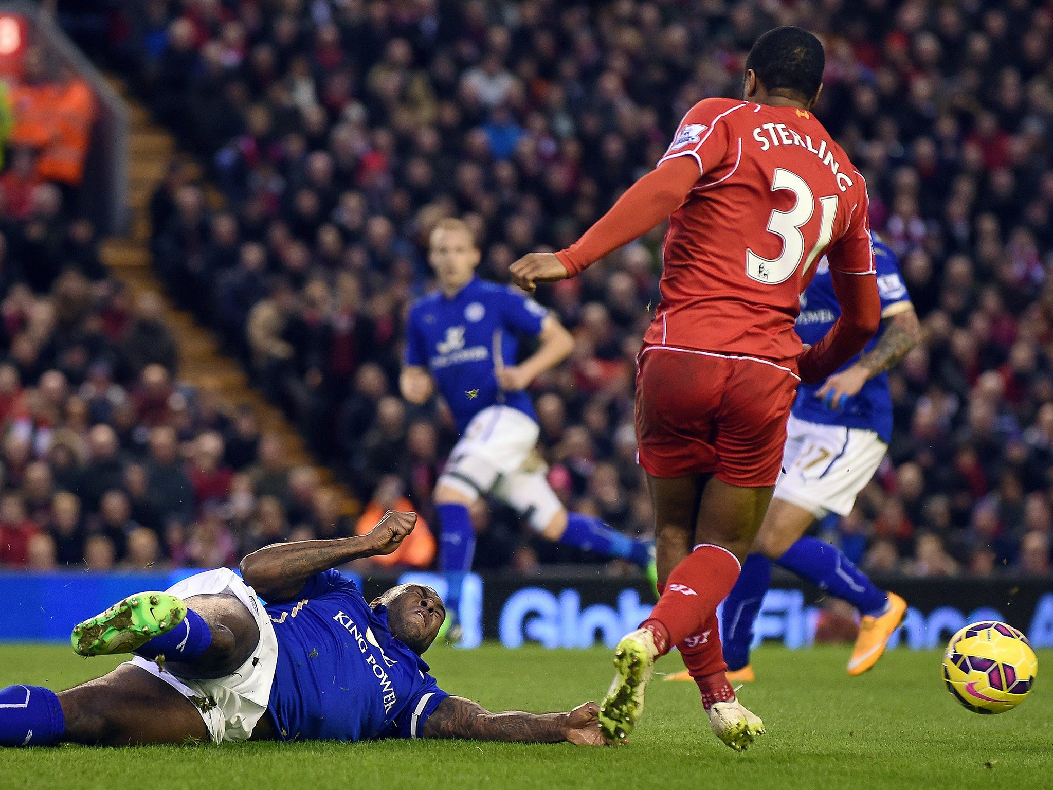 Leicester City defender Wes Morgan is pictured conceeding a penalty with a 'handball' for the first Liverpool penalty