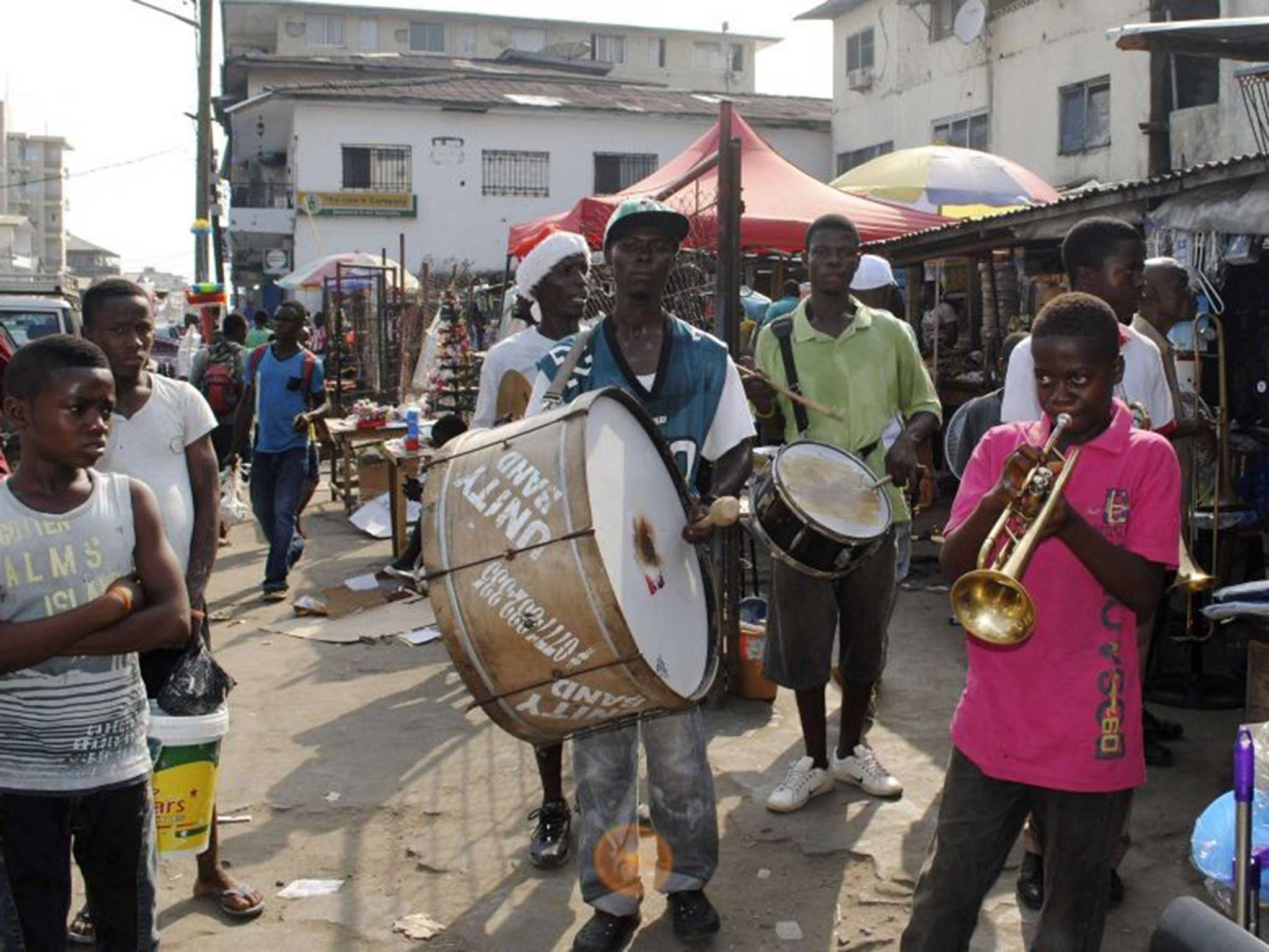 A marching band performs on the street in Monrovia as the city attempted to celebrate the festive period with some degree of normality