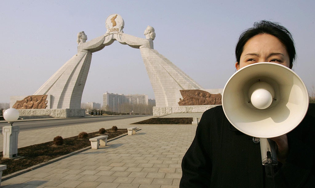 A North Korean tour guide talks about the Reunification Monument in the capital of Pyongyang