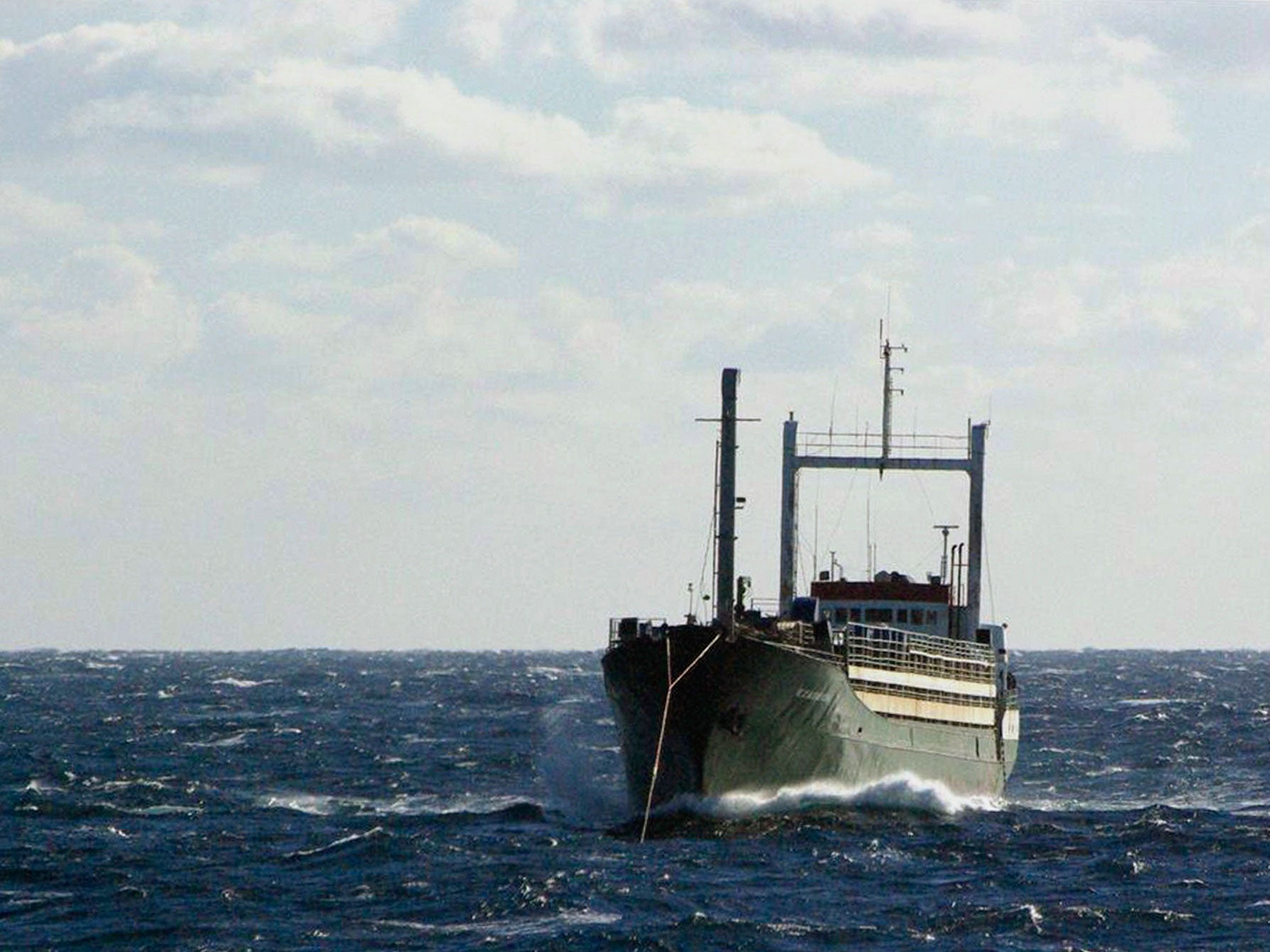 Sierra Leone-flagged Ezadeen vessel, carrying hundreds of migrants, is towed by the Icelandic Coast Guard vessel Tyr in rough seas in the Mediterranean sea off Italy's south coast in this handout provided by the Icelandic Coast Guard January 2, 2015.