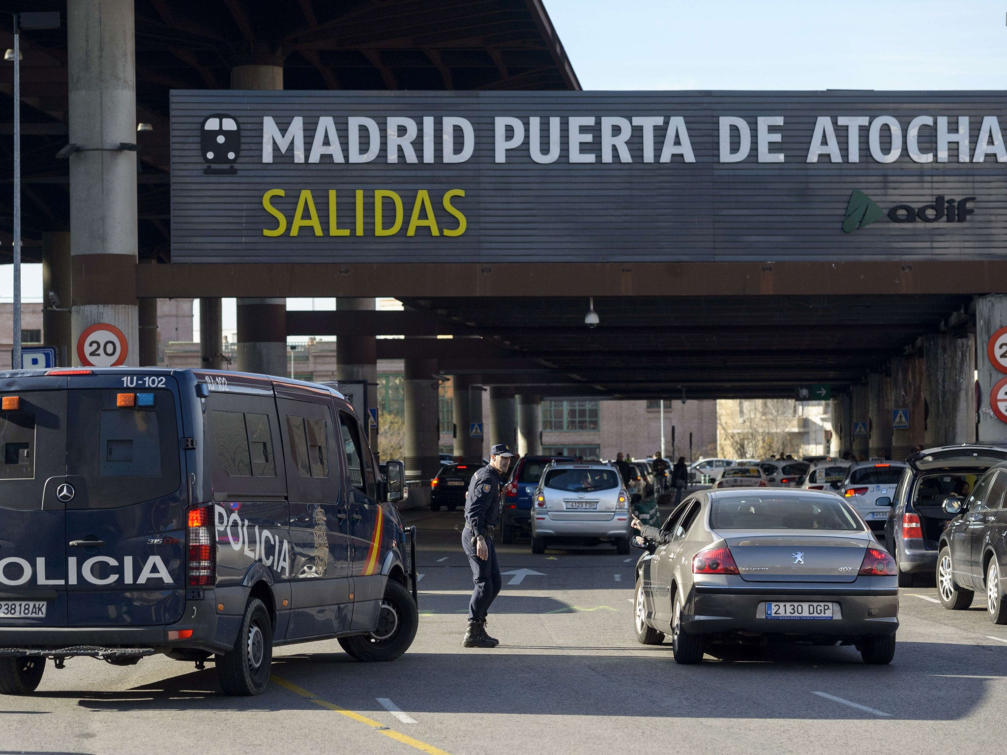 Police deviate traffic at the entrance to Madrid's Atocha railway station following a false alert when a man threatened to blow himself up. Police said a man claiming to be carrying a bomb in his backpack was arrested, but nothing was found