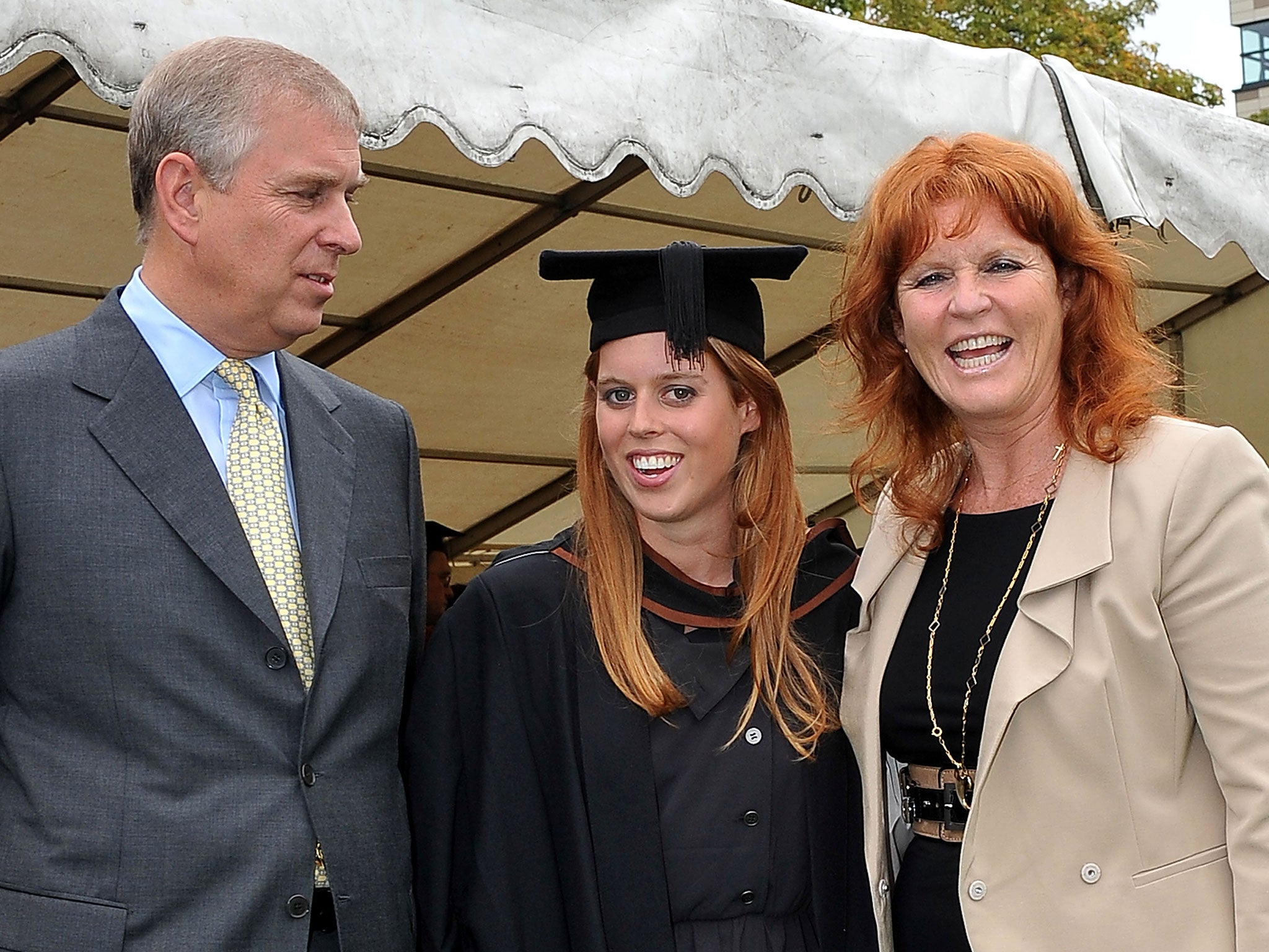 Princess Beatrice (C) poses for photograph with her parents, Britain's Prince Andrew, the Duke York (L) and Sarah Ferguson following her graduation ceremony at Goldsmiths College, in London