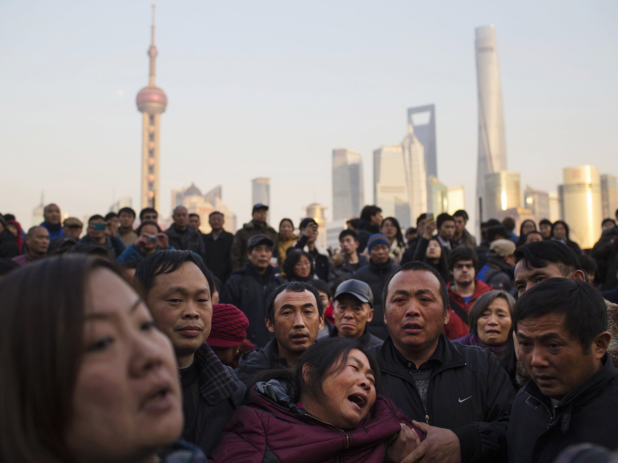 The mother of a victim weeps at the scene of the New Year’s Eve stampede on Shanghai’s
waterfront