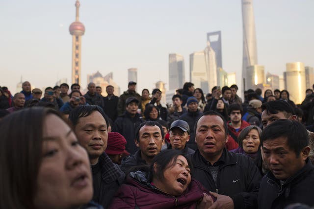 The mother of a victim weeps at the scene of the New Year’s Eve stampede on Shanghai’s
waterfront