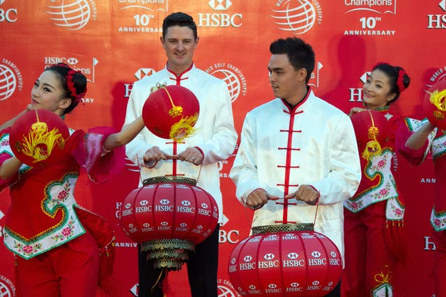 Golfers Justin Rose (2nd L) of England and Rickie Fowler of the US (C), wearing Chinese costumes, take part in a photo call for the WGC-HSBC Champions golf tournament on the historic Bund in Shanghai