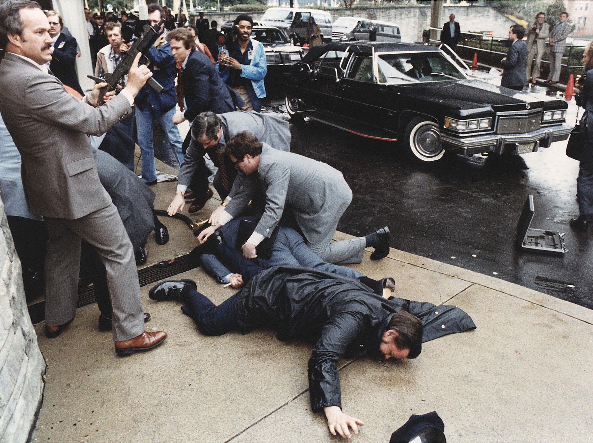 James Brady, in light blue suit, lies injured after attack on Ronald Reagan