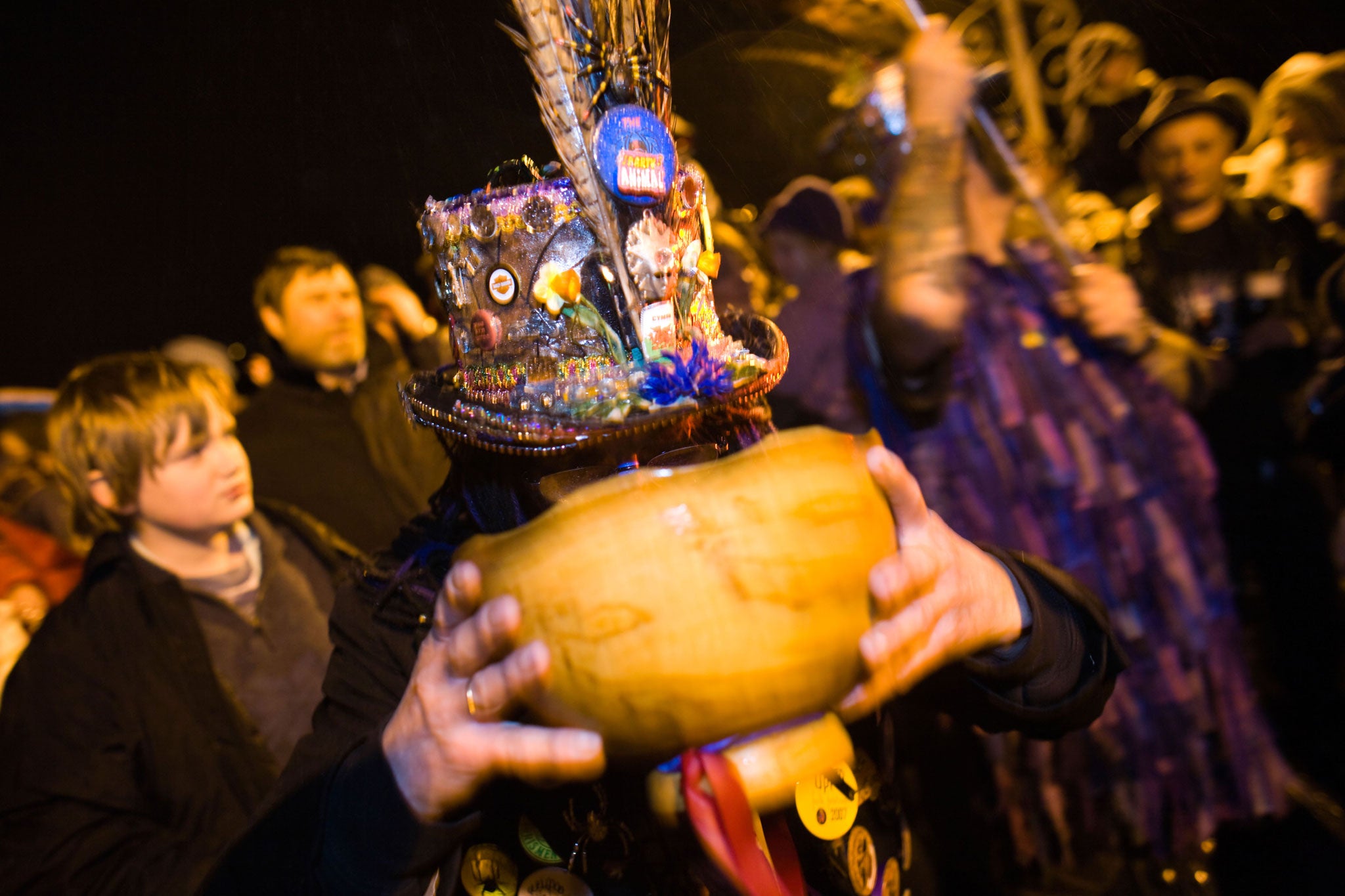 A reveller drinks from the wassail bowl at the Chepstow Wassail in Wales