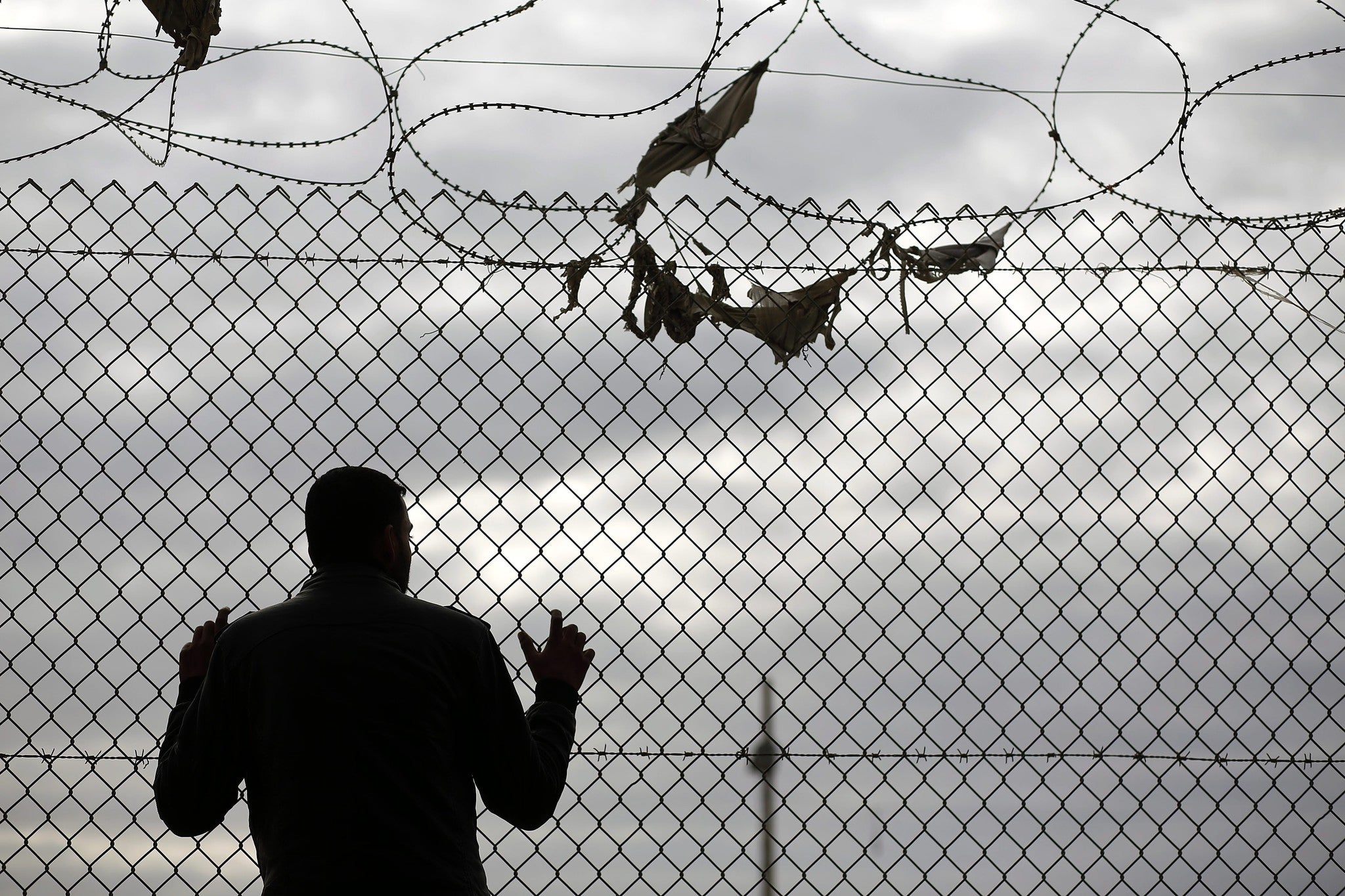 A Palestinian waits to cross the border at Rafah in December 2014