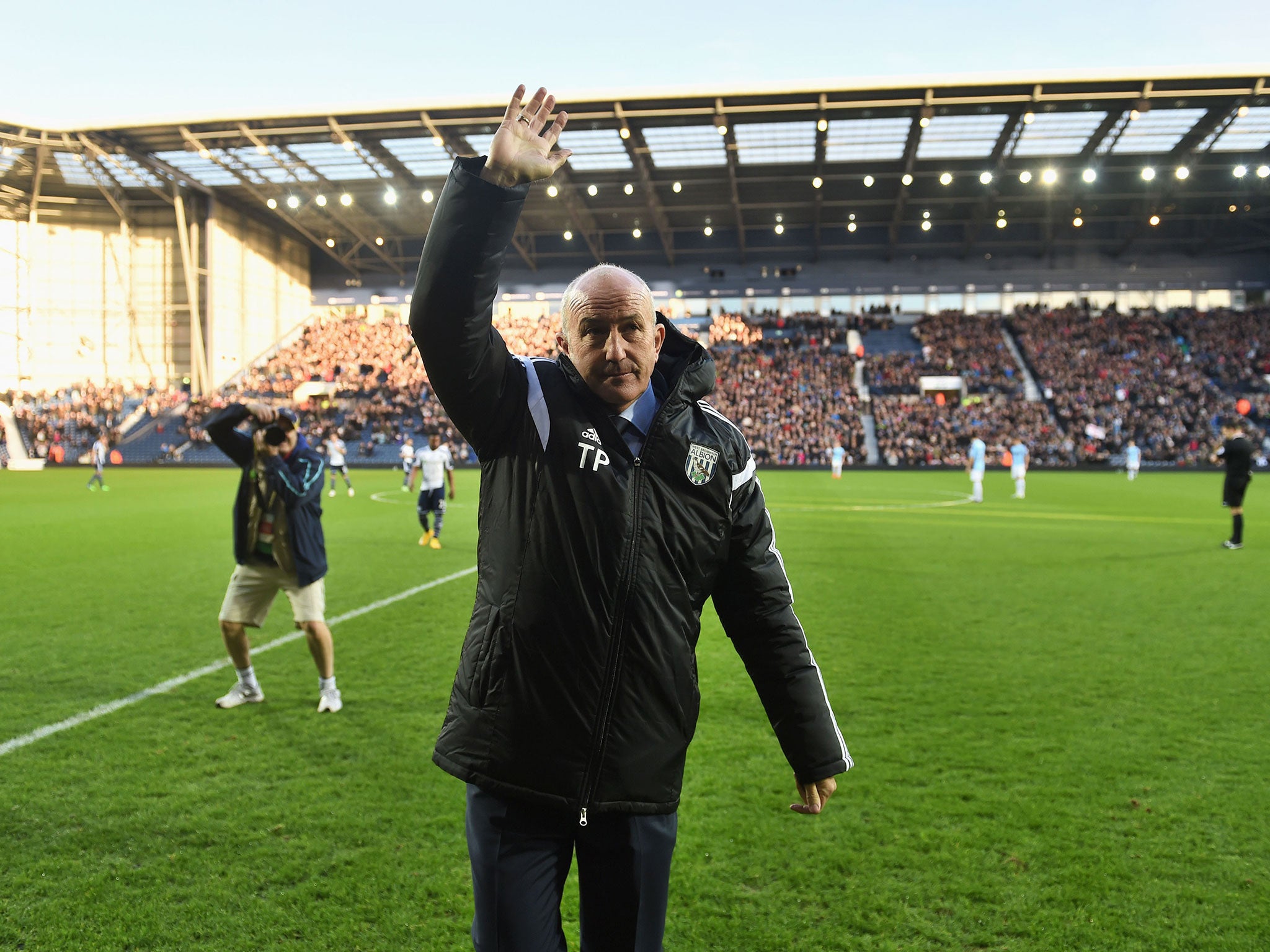 Tpny Pulis waves to the crowd ahead of his first game in charge of West Brom