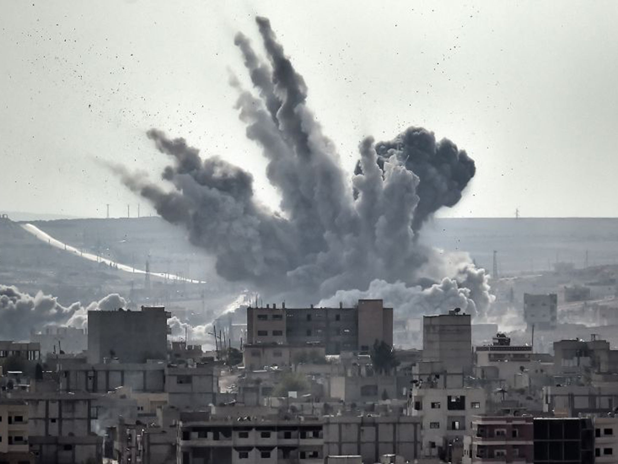 A shell explodes in Kobani, just one of the fronts where IS fighters are engaged (AFP/Getty)
