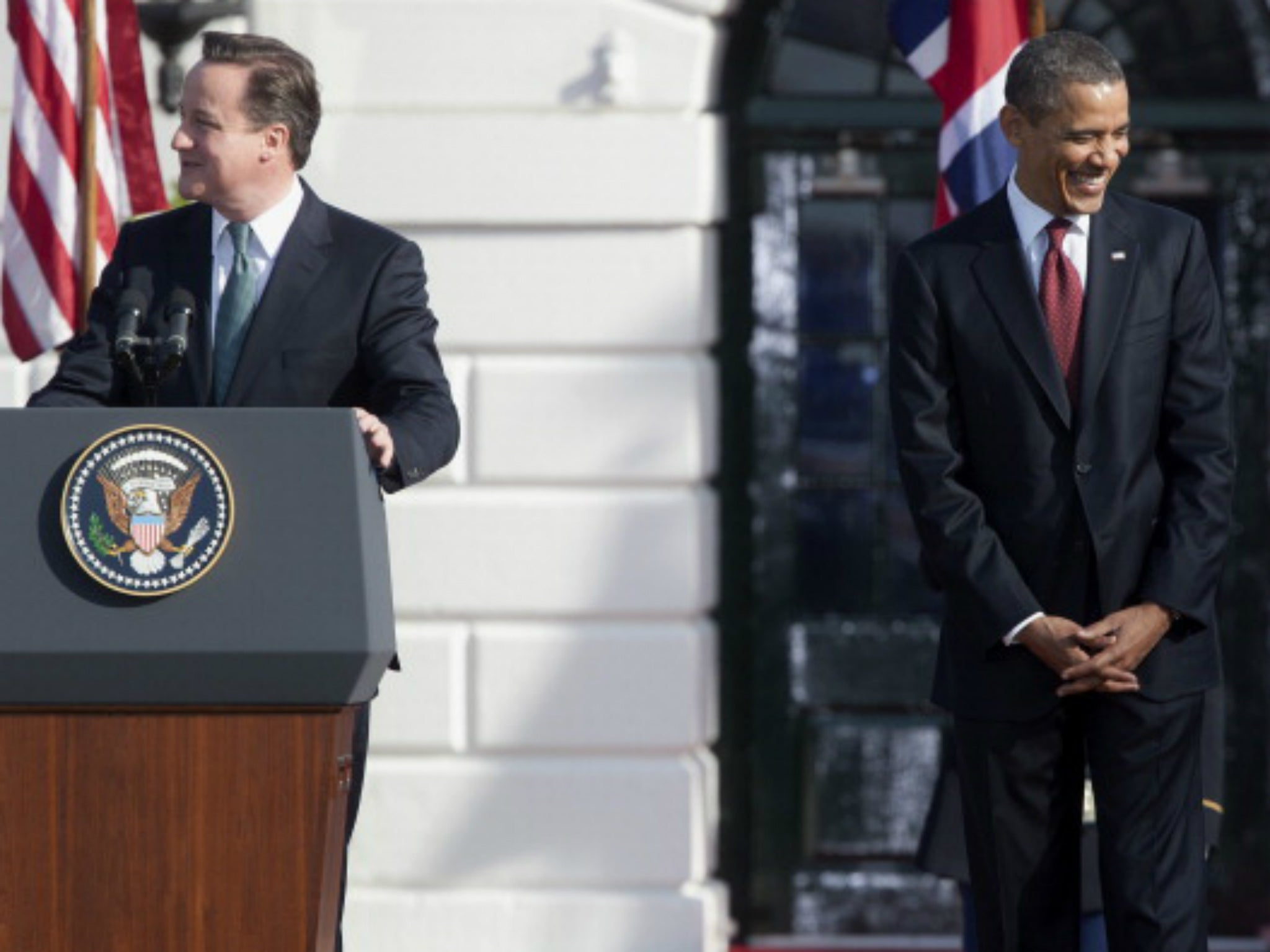 Obama enjoying one of Cameron's jokes at a visit to the White House