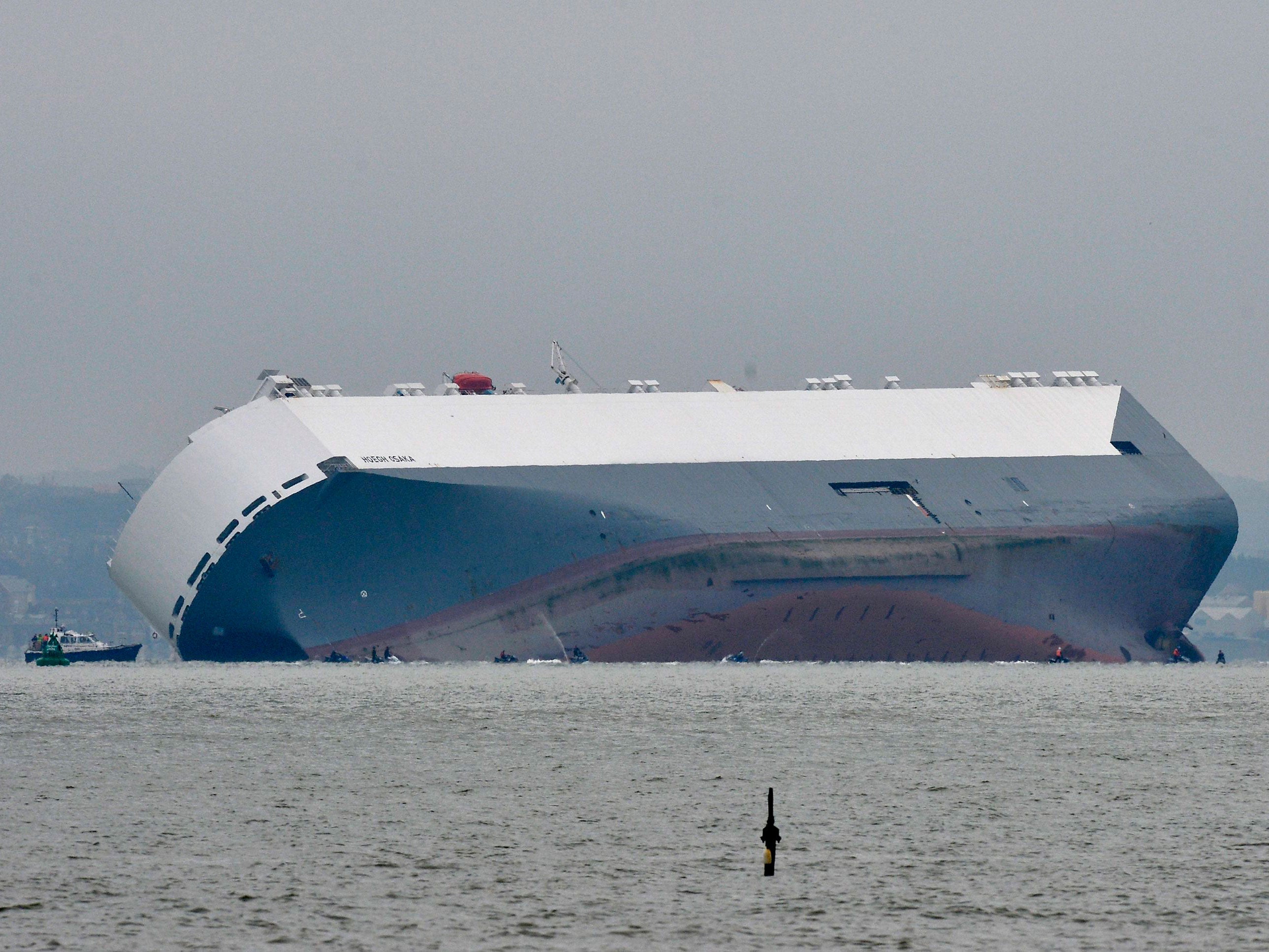 The Hoegh Osaka, a car carrier, is seen from Calshot in Hampshire after the ship became stranded on Bramble Bank, in the Solent between Southampton and the Isle of Wight