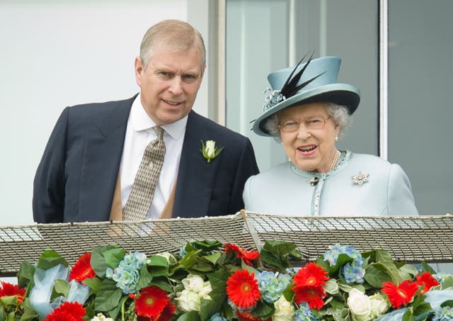 Prince Andrew speaks to the Queen during Derby day at the Epsom Derby Festival, 2013.