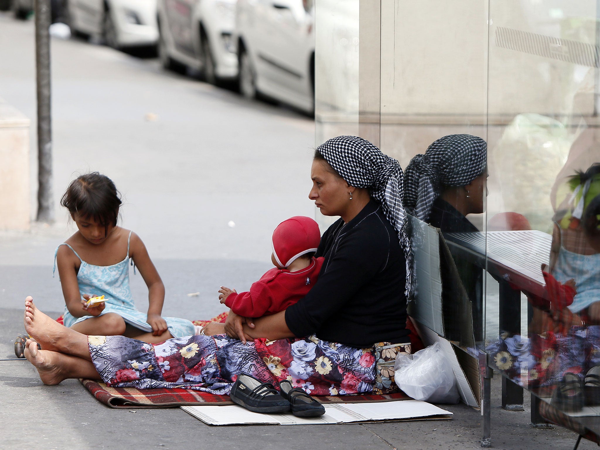 A Roma woman and her children beg on the streets. The French government seeks to end a row over its treatment of ethnic Roma migrants in a move that could result in Bulgarian and Romanian citizens being granted the right to work in France
