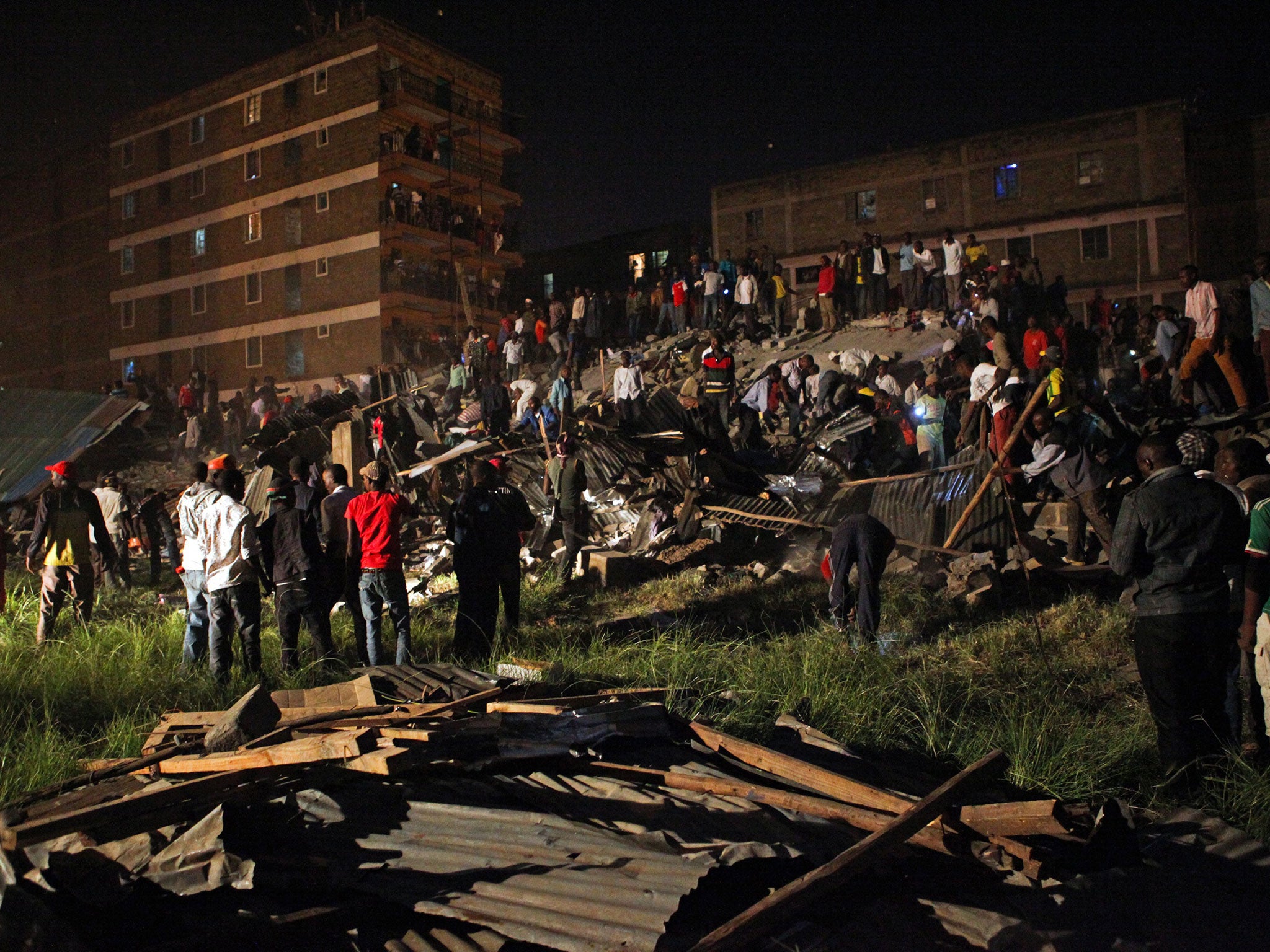 Locals at a scene trying to rescue survivors from the rubble of a seven-storey building which collapsed in the Huruma area of Nairobi, Kenya
