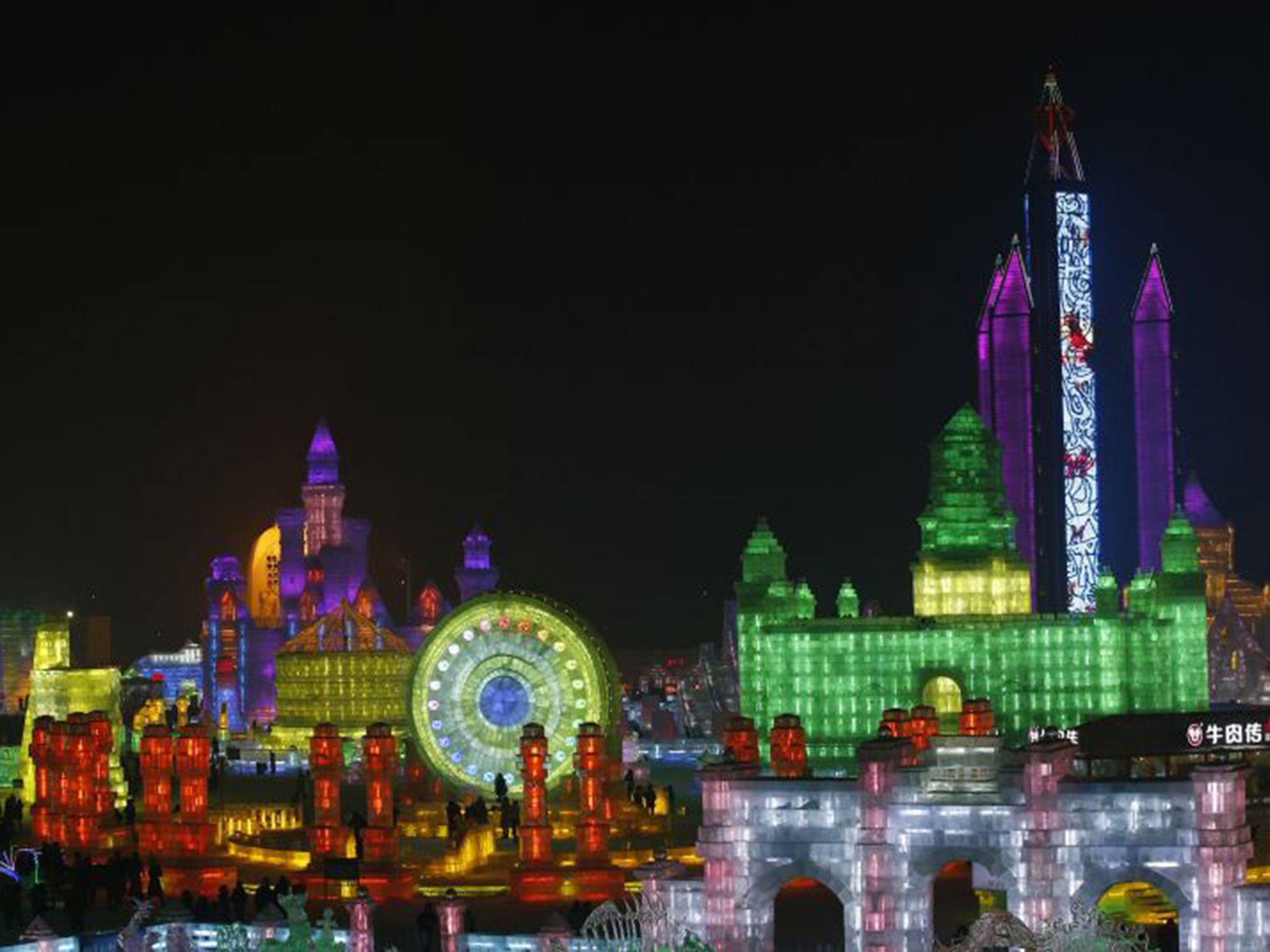 People visit a maze which was built by ice bricks and illuminated by coloured lights during a trial operation ahead of the 31st Harbin International Ice and Snow Festival in the northern city of Harbin, Heilongjiang province, January 4, 2015. The winter f