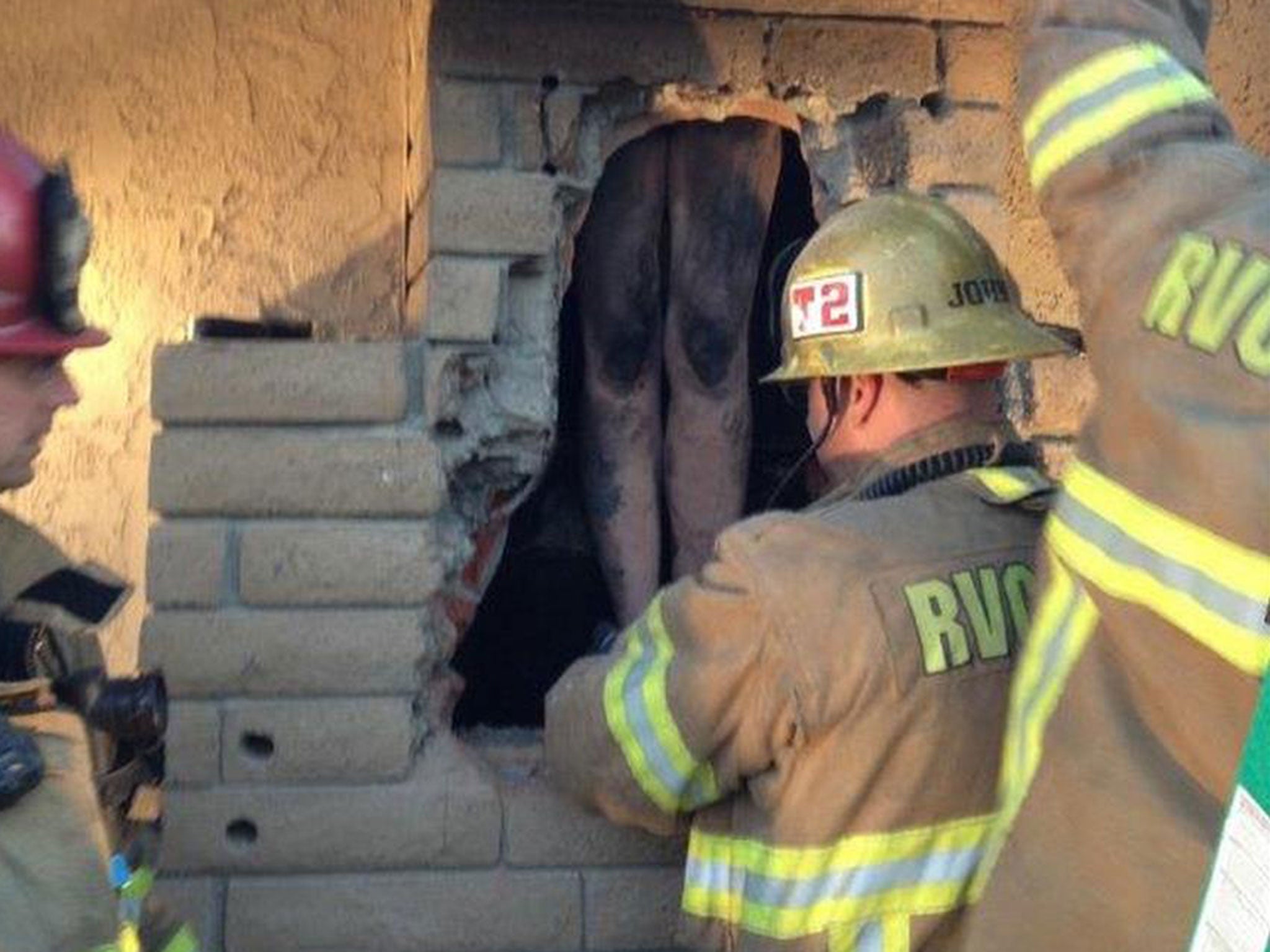 Firefighters rescued a naked woman stuck in a chimney in California.