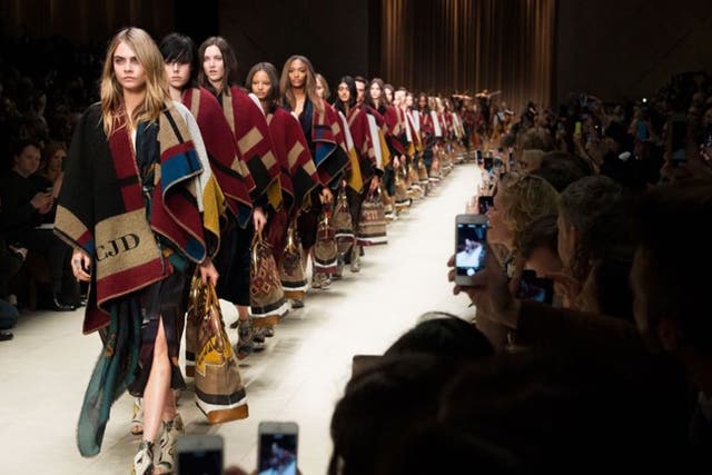 Cara Delevingne sports a monogramed blanket in the A/W 15 Burberry Prorsum show