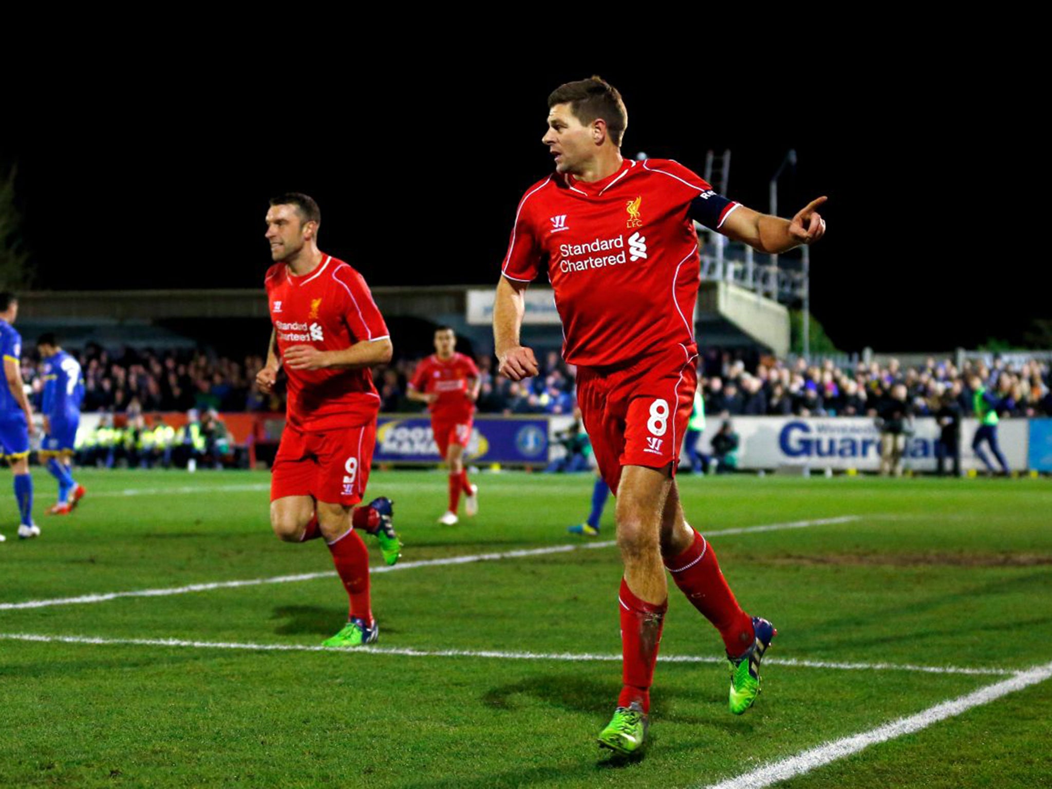 Steven Gerrard celebrates giving Liverpool the lead with the first of his two goals against AFC Wimbledon on Monday night (Getty)