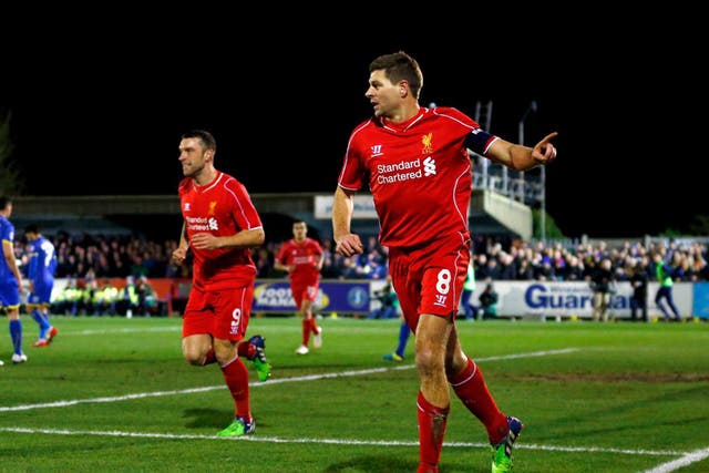 Steven Gerrard celebrates giving Liverpool the lead with the first of his two goals against AFC Wimbledon on Monday night (Getty)