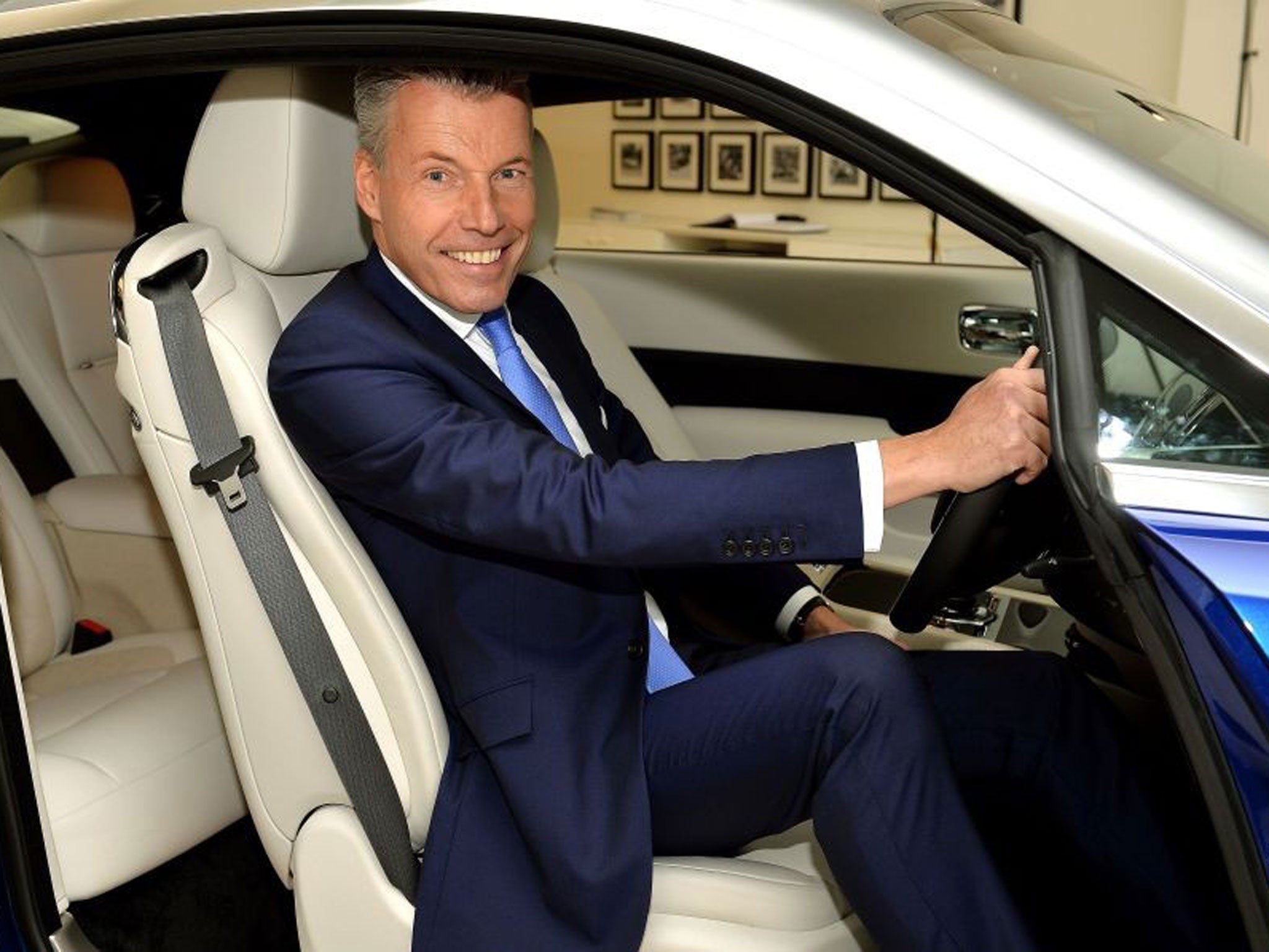 Chief executive of Rolls-Royce Motor Cars Torsten Muller Otvos sits in a Rolls-Royce car in the company's Berkley Square showroom in Mayfair, London