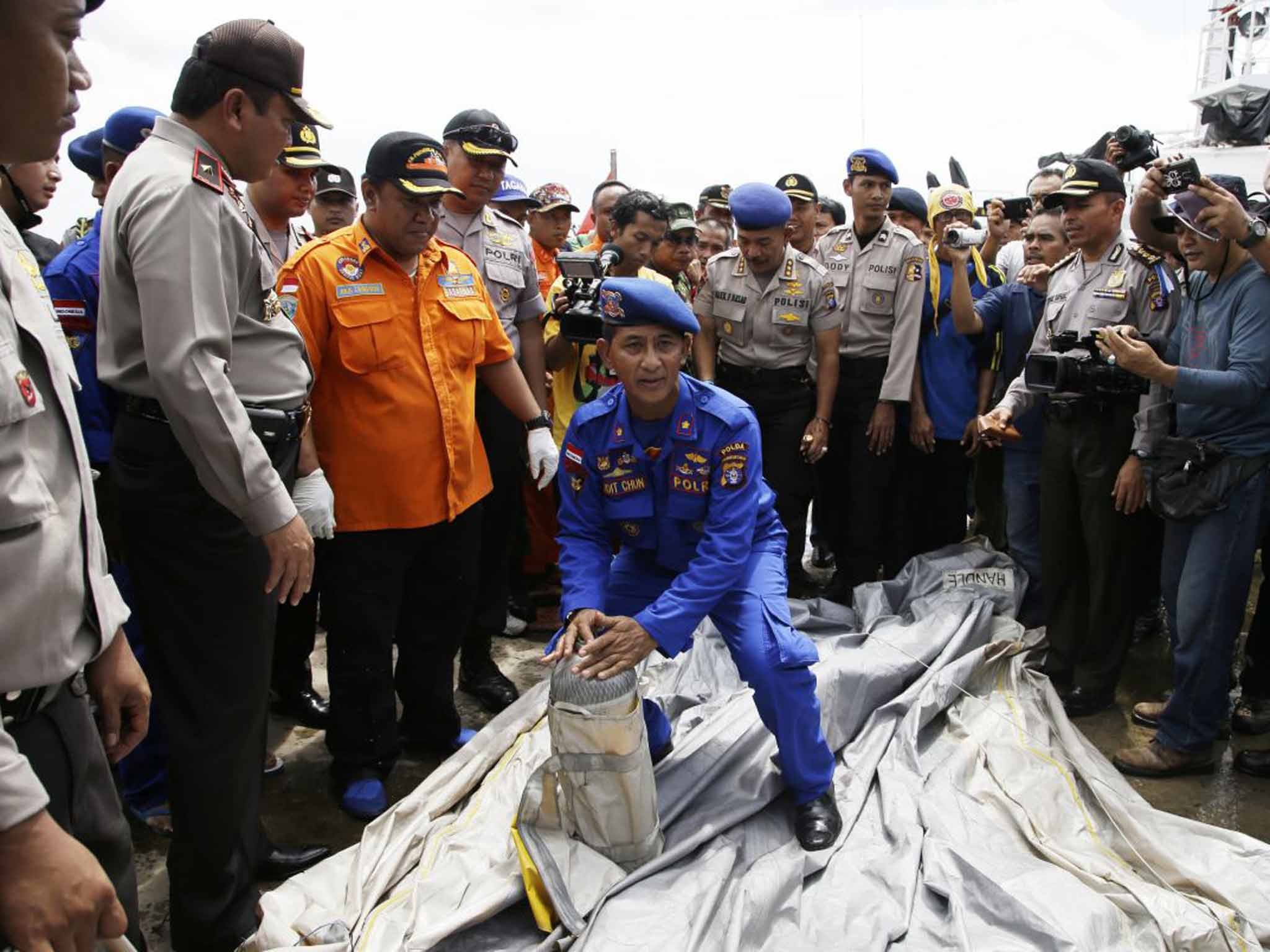 The 21st century team: Indonesian police with parts of AirAsia Flight 8501