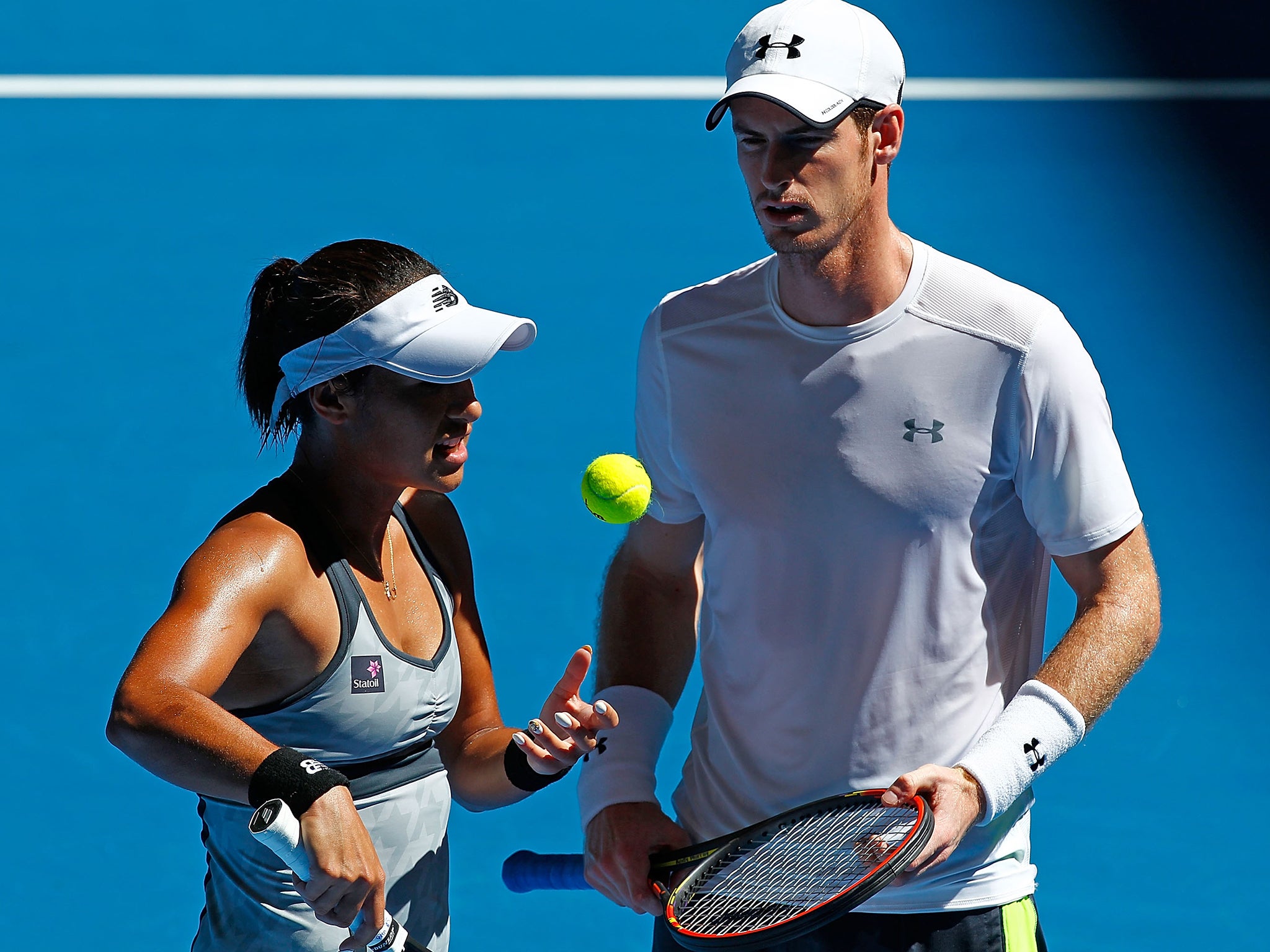 Heather Watson and Andy Murray of Great Britain talk in-between serves in the mixed doubles match against Jerzy Janowicz and Agnieszka Radwansk