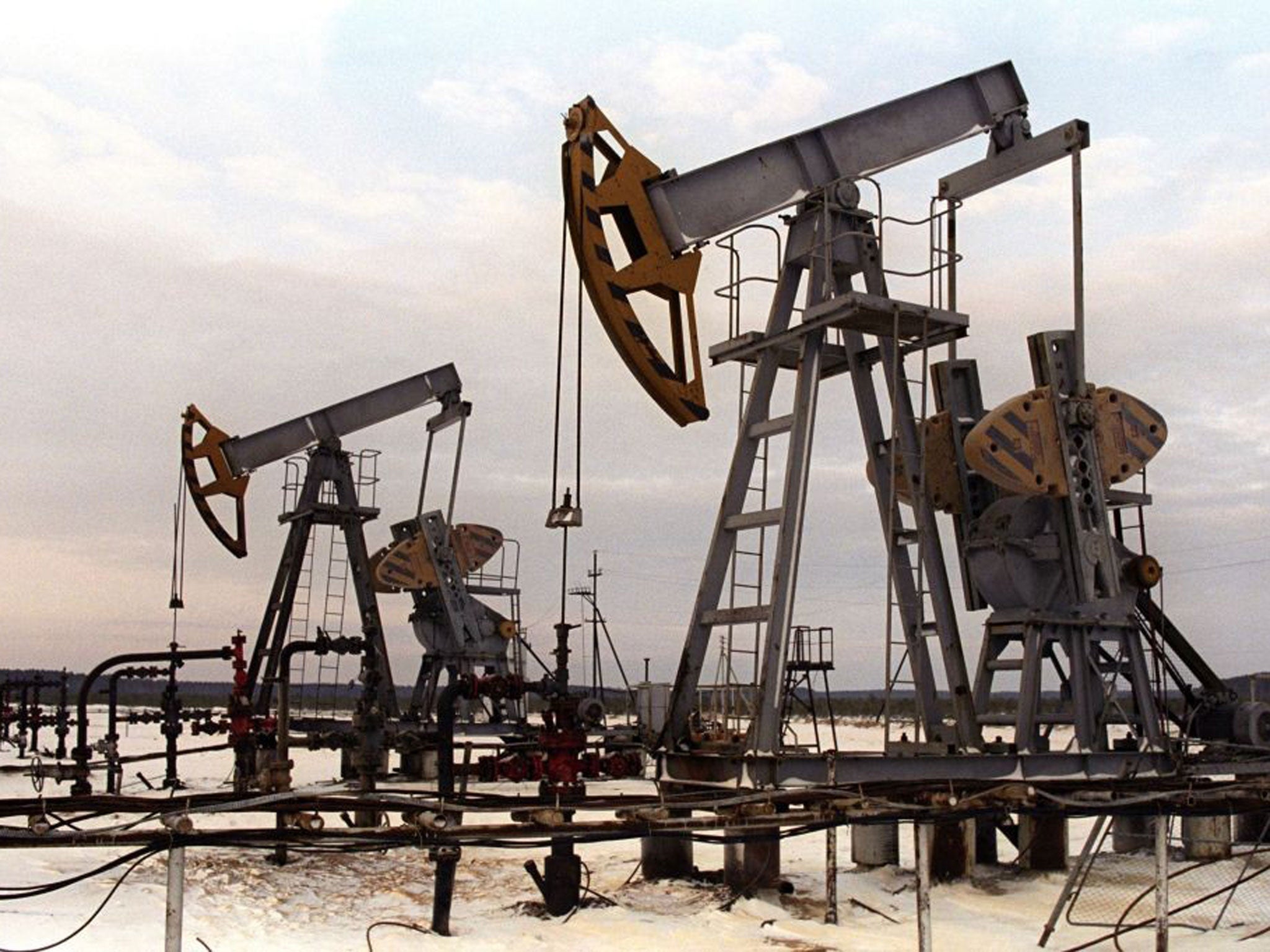 A photo dated 22 November 1992 showing oil-pumping equipment standing abandoned at the oil well site near Surgut in Siberia, Russia