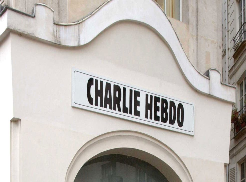 Police officers and firefighters gather in front of the offices of the French satirical newspaper Charlie Hebdo in Paris, after armed gunmen stormed the offices leaving "casualties", according to the publication's cartoonist, and "six seriously injured" p