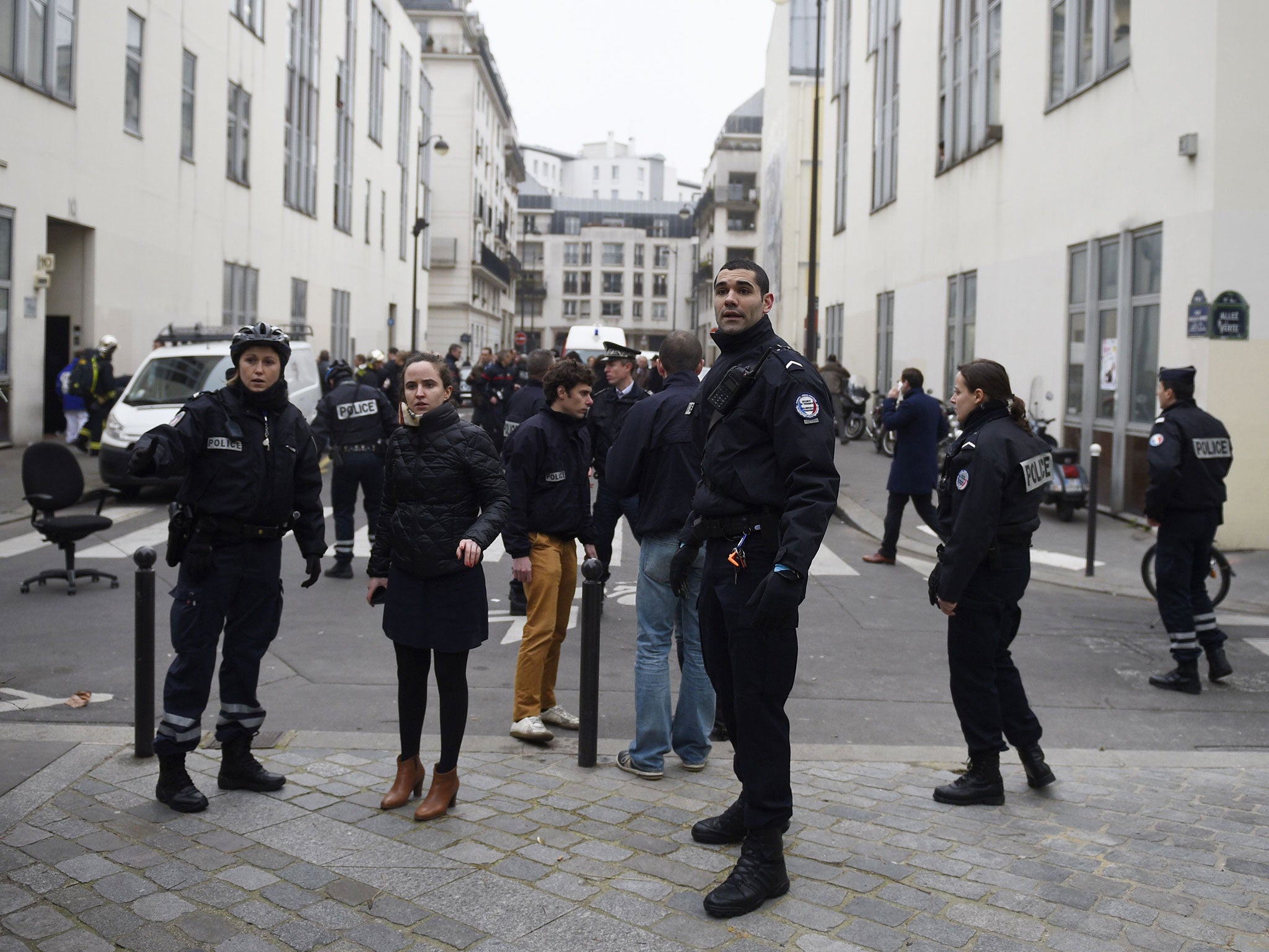 Police forces gather in street outside the offices of the French satirical newspaper Charlie Hebdo in Paris 