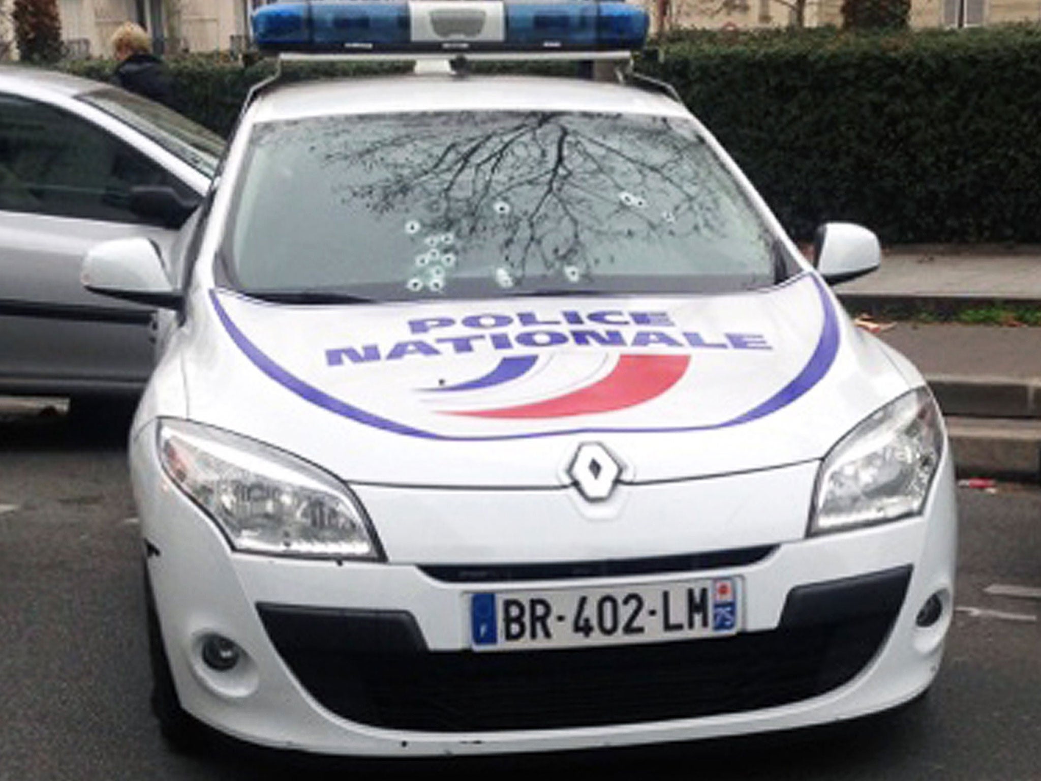 A police car riddled with bullets outside the offices of Charlie Hebdo in Paris (Getty)