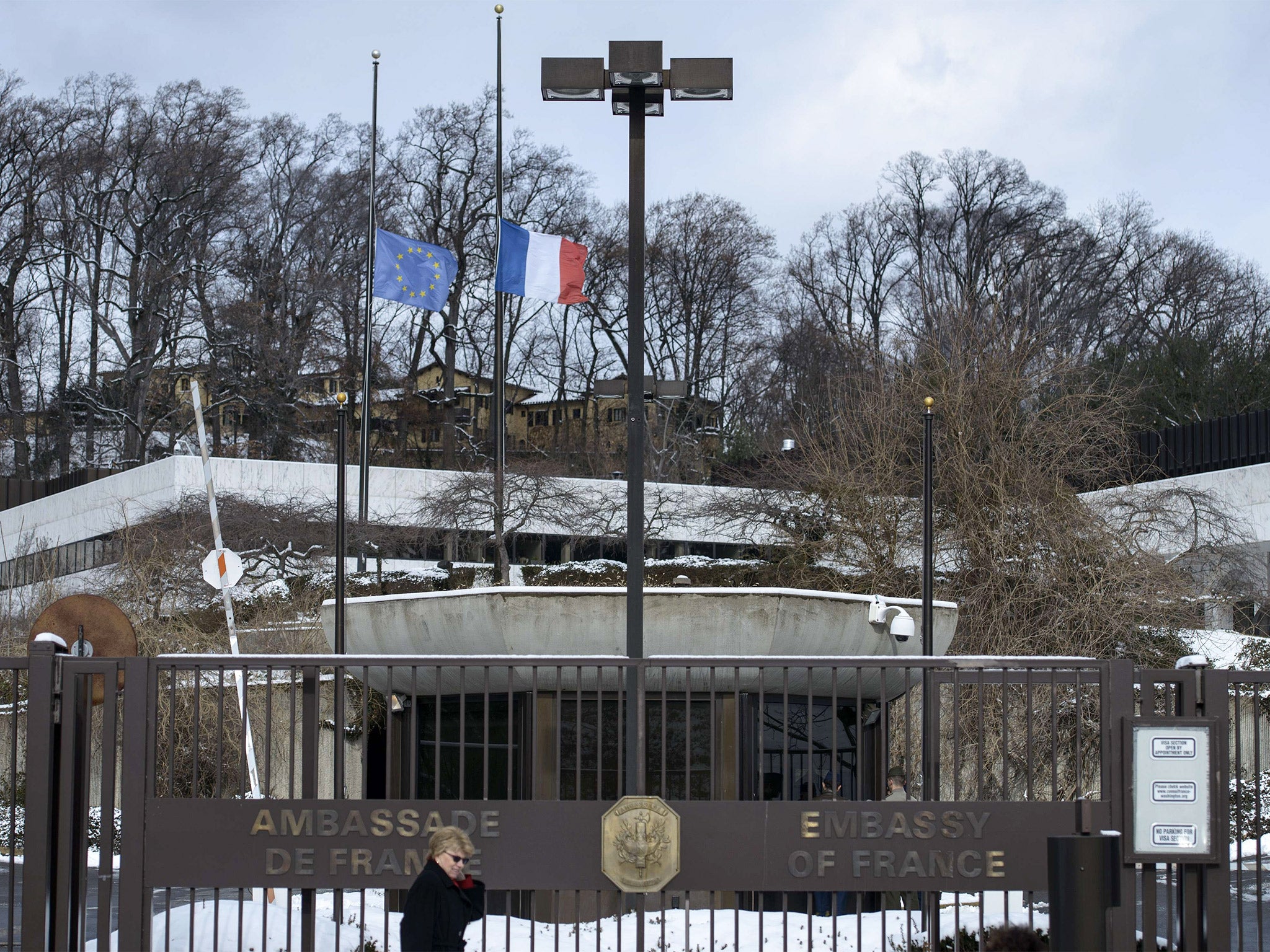 The French and European union flags fly at half-mast at the French Embassy in Washington, DC (Getty)