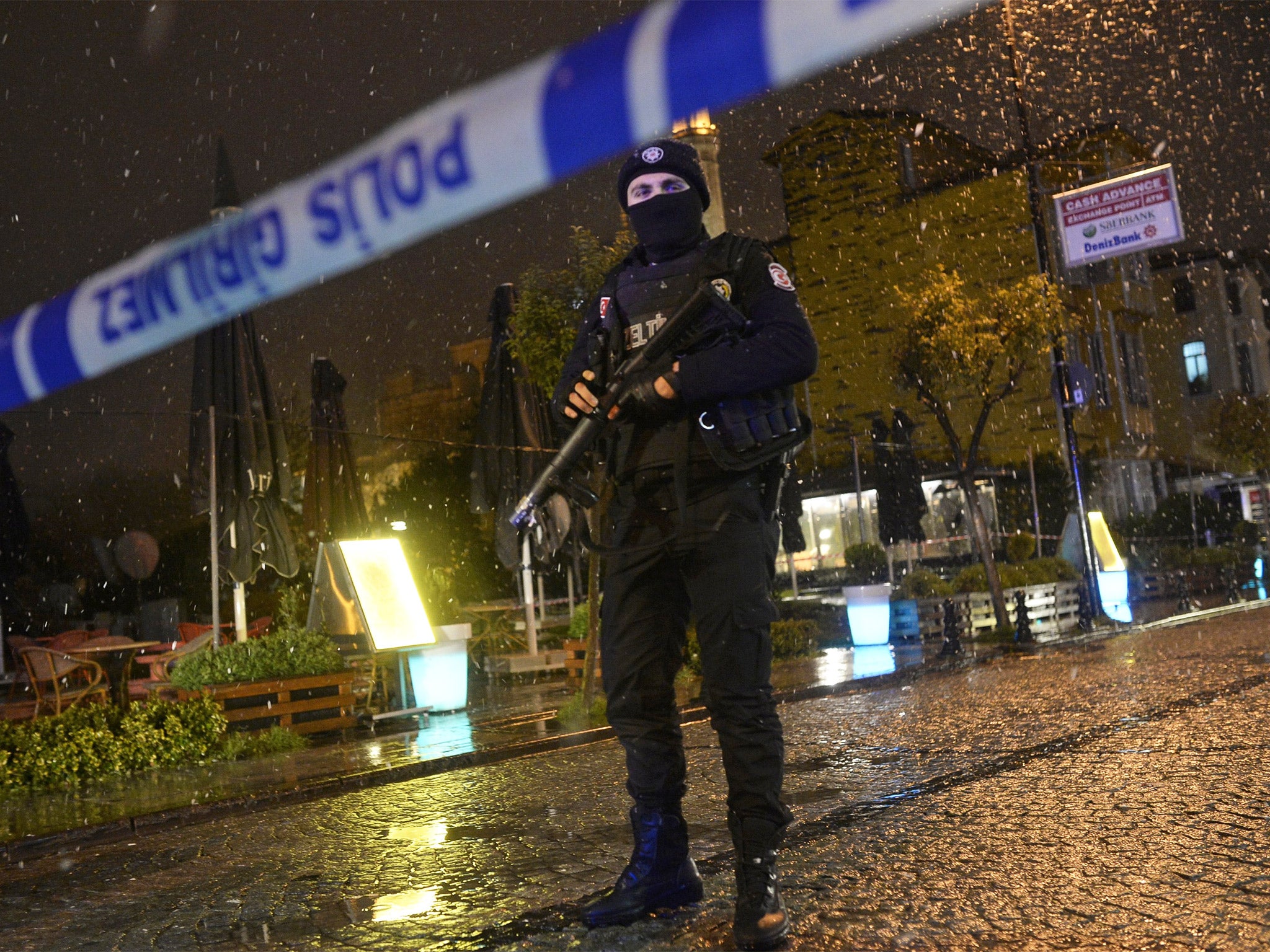 A police officer stands guard along a street near the attack