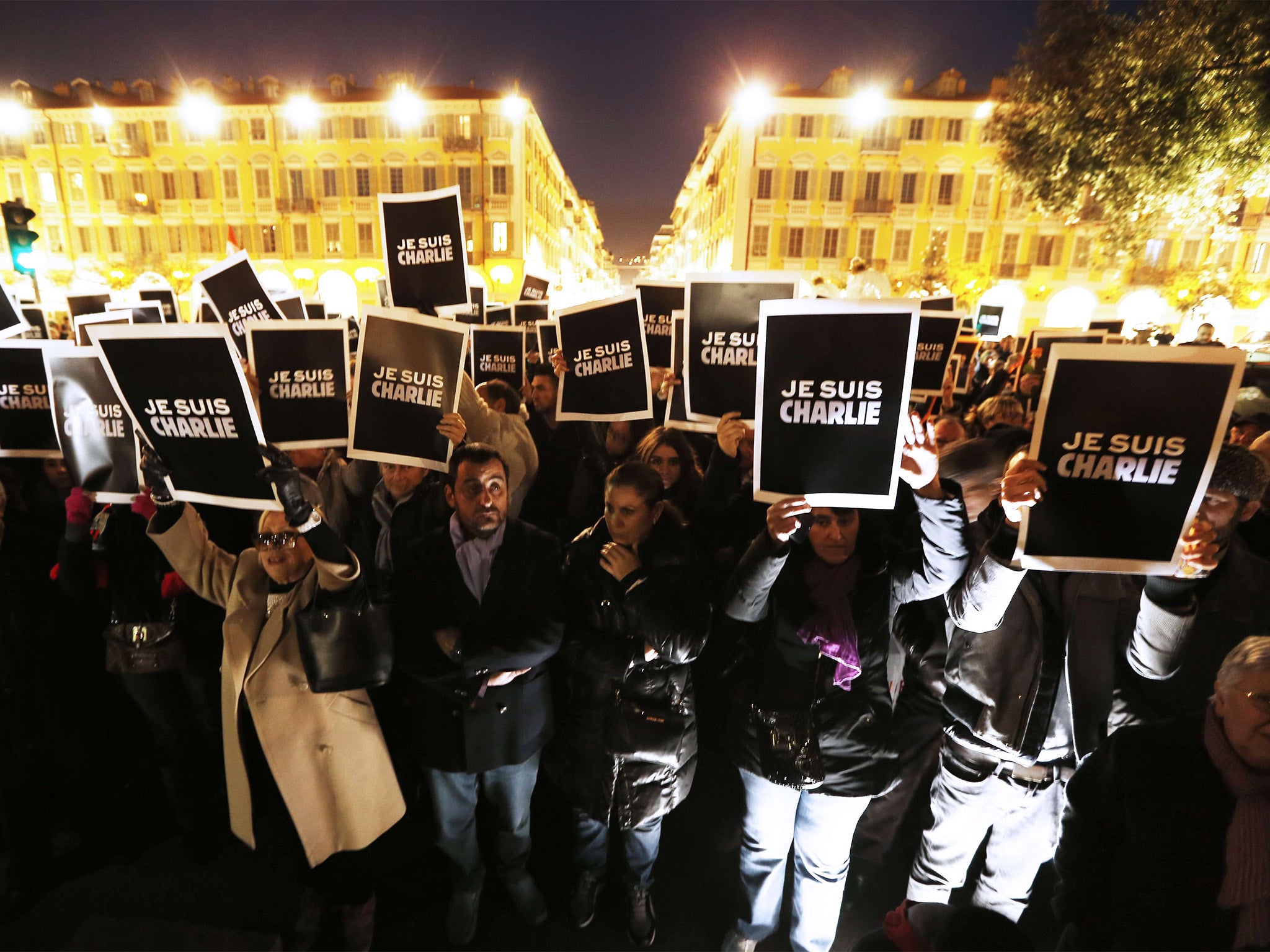 People hold up placards reading 'I am Charlie' during a gathering in Nice