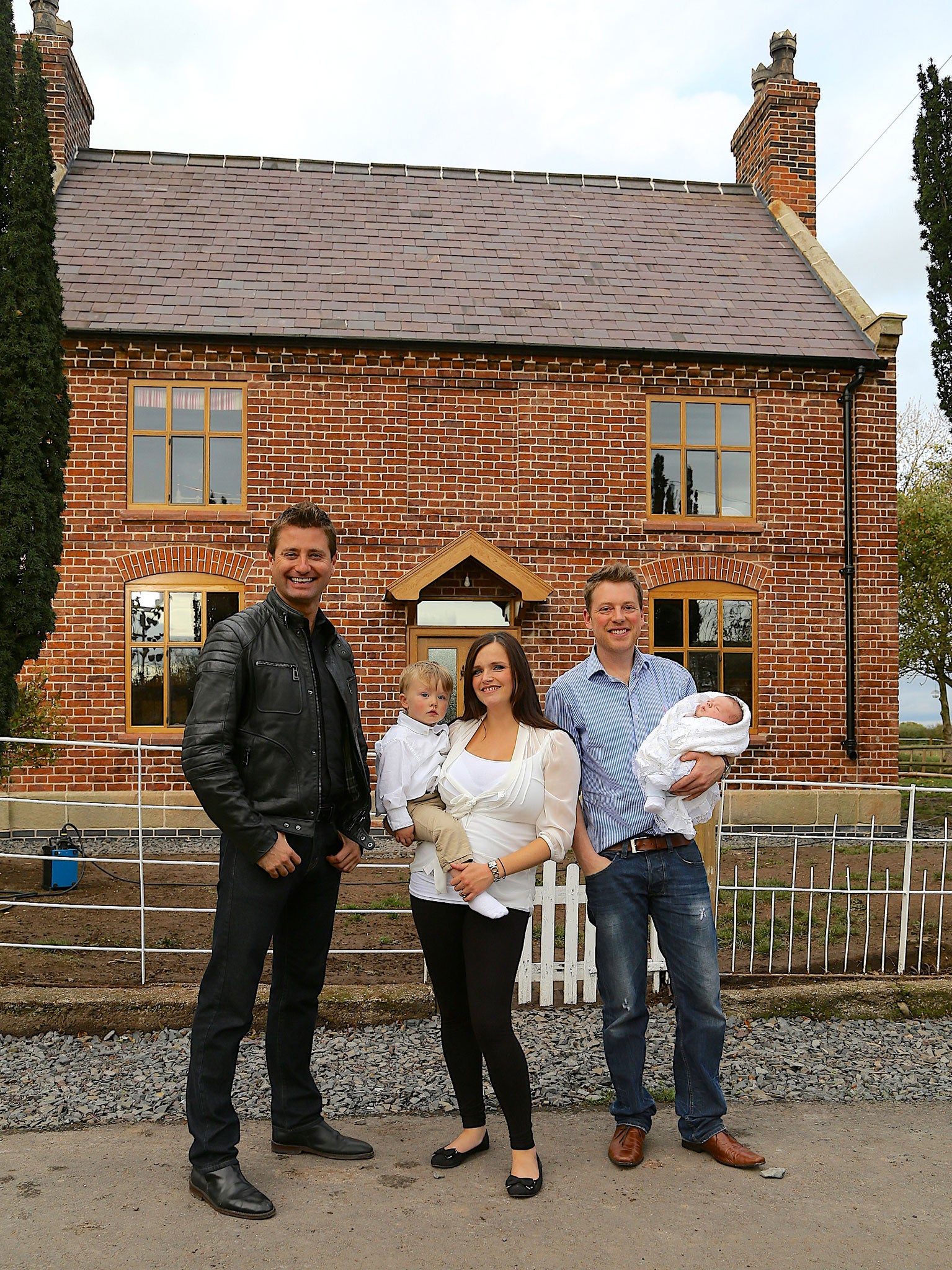 George Clarke (left) with Russell and Nadia outside their cottage in Shropshire