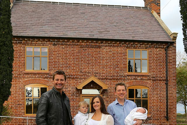 George Clarke (left) with Russell and Nadia outside their cottage in Shropshire