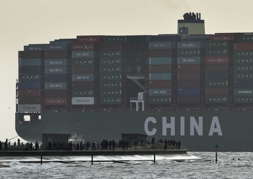 Onlookers watch from a harbour wall as the largest container ship in world, CSCL Globe, docks during its maiden voyage, at the port of Felixstowe in south east England