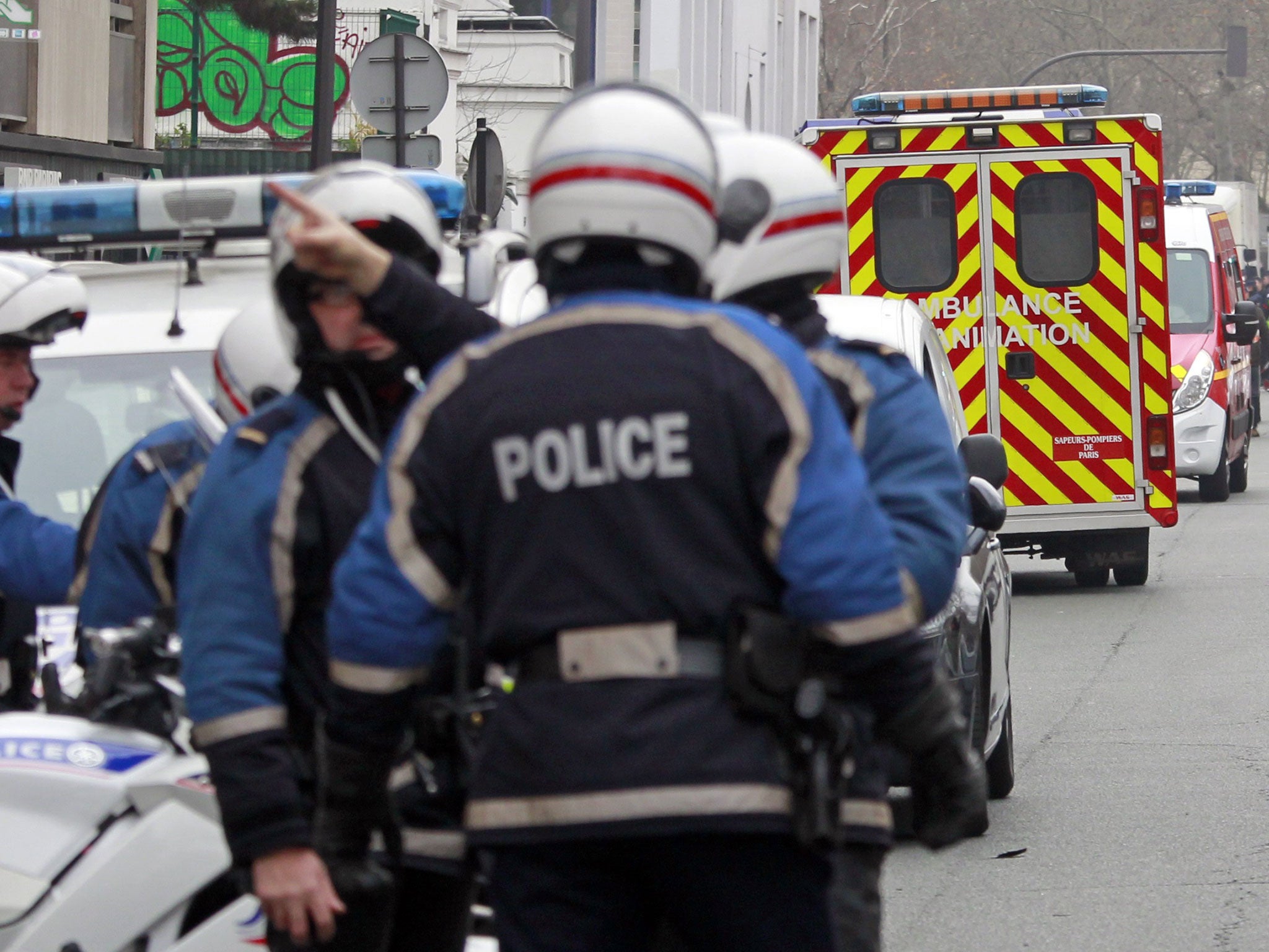French police at the scene of the Charlie Hebdo massacre yesterday
