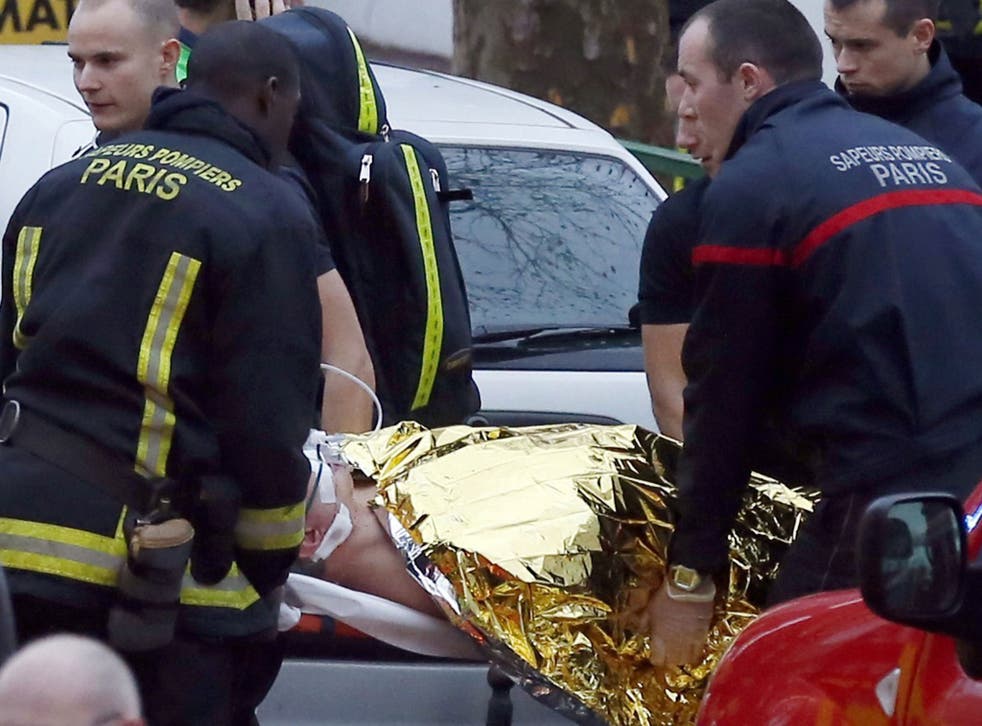 Emergency workers tend to one of the injured after the shooting in the Montrouge area in southern Paris