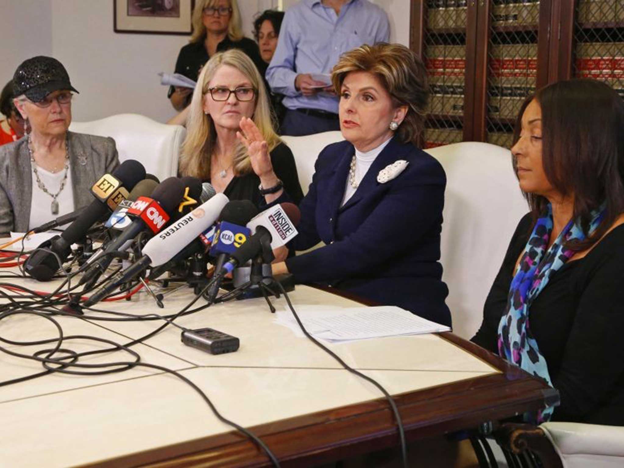 Three women who allege they were sexually assaulted by comedian Bill Cosby, Linda Kirkpatrick (2nd from left) and two unidentified women, sit with lawyer Gloria Allred