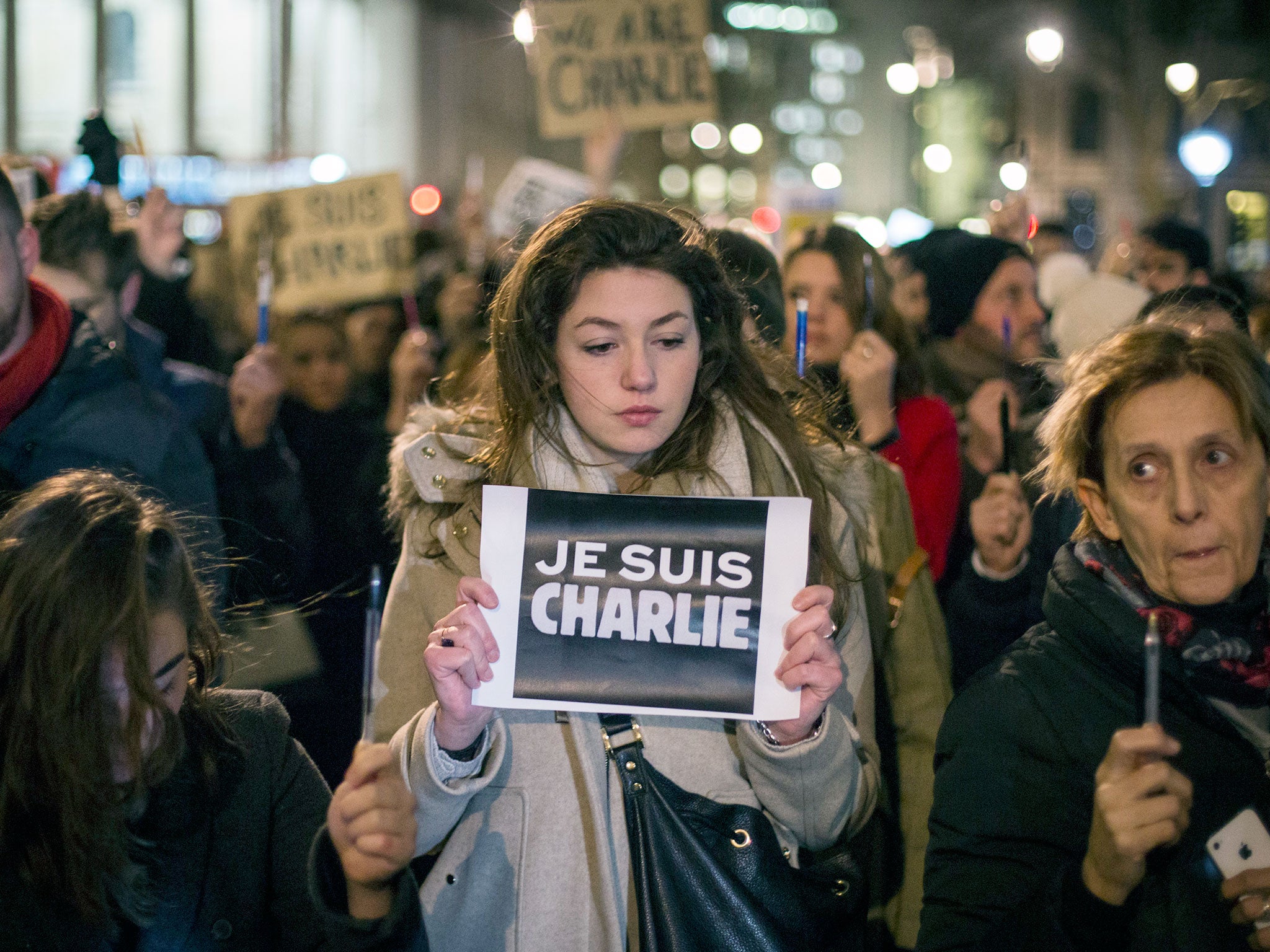 A woman holds a poster reading 'Je suis Charlie' (I am Charlie) during a vigil in Trafalgar Square in London for victims of the terrorist attack at Charlie Hebdo in Paris