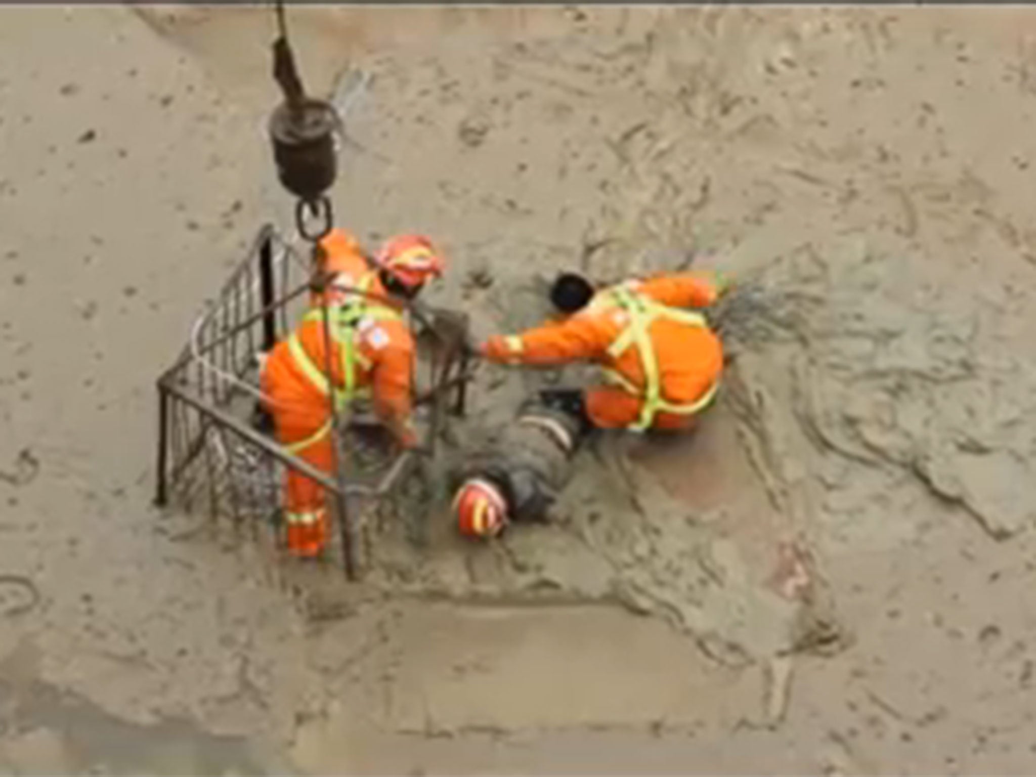 The man was stuck for nearly an hour before rescue workers pulled him out of the mud