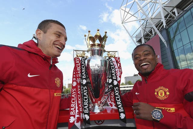 Nemanja Vidic (left) and Patrice Evra with the Premier League Trophy in 2013
