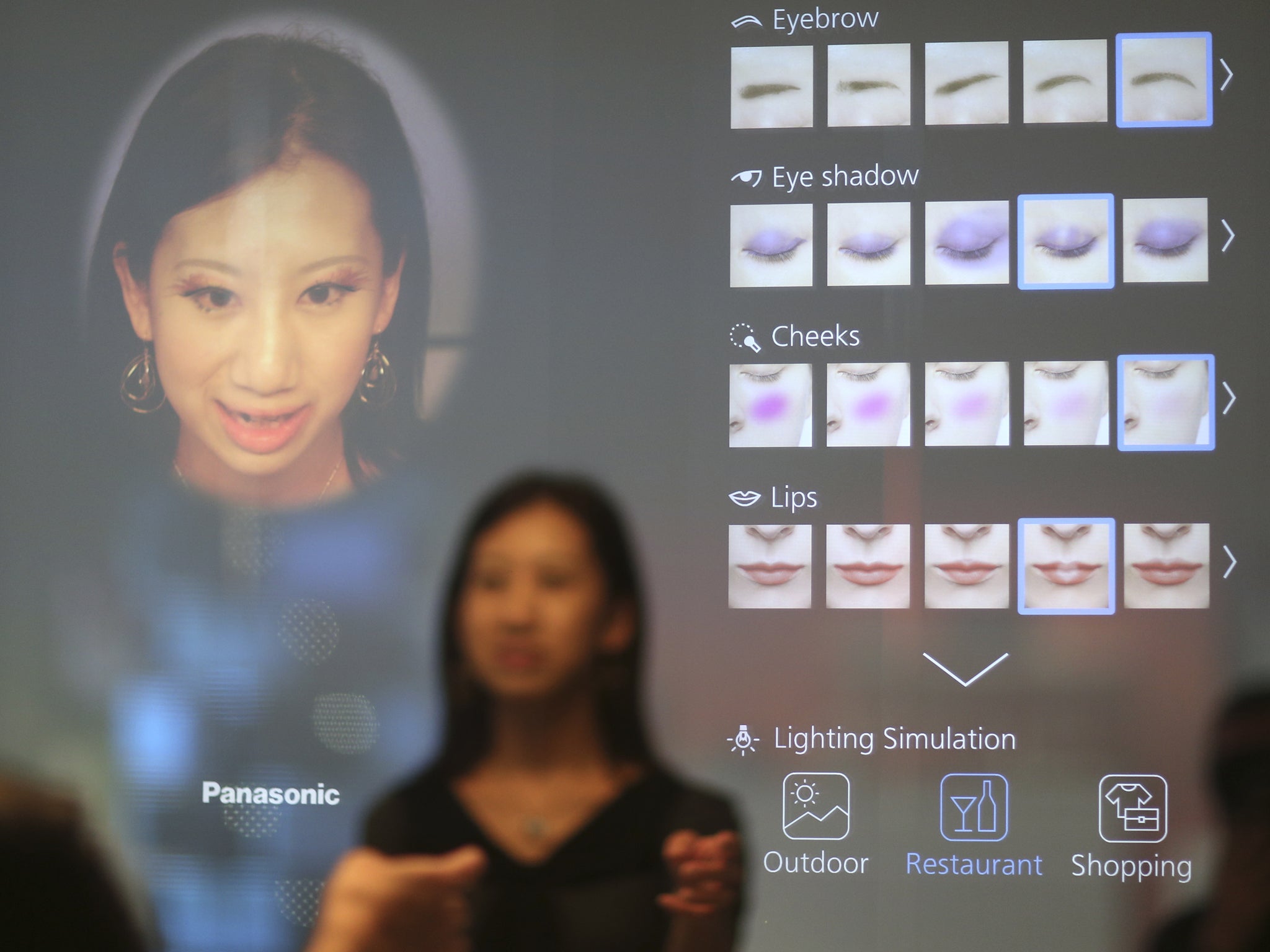 A visitor checks a Panasonic interactive mirror concept during the IFA Electronics show in Berlin September 4, 2014