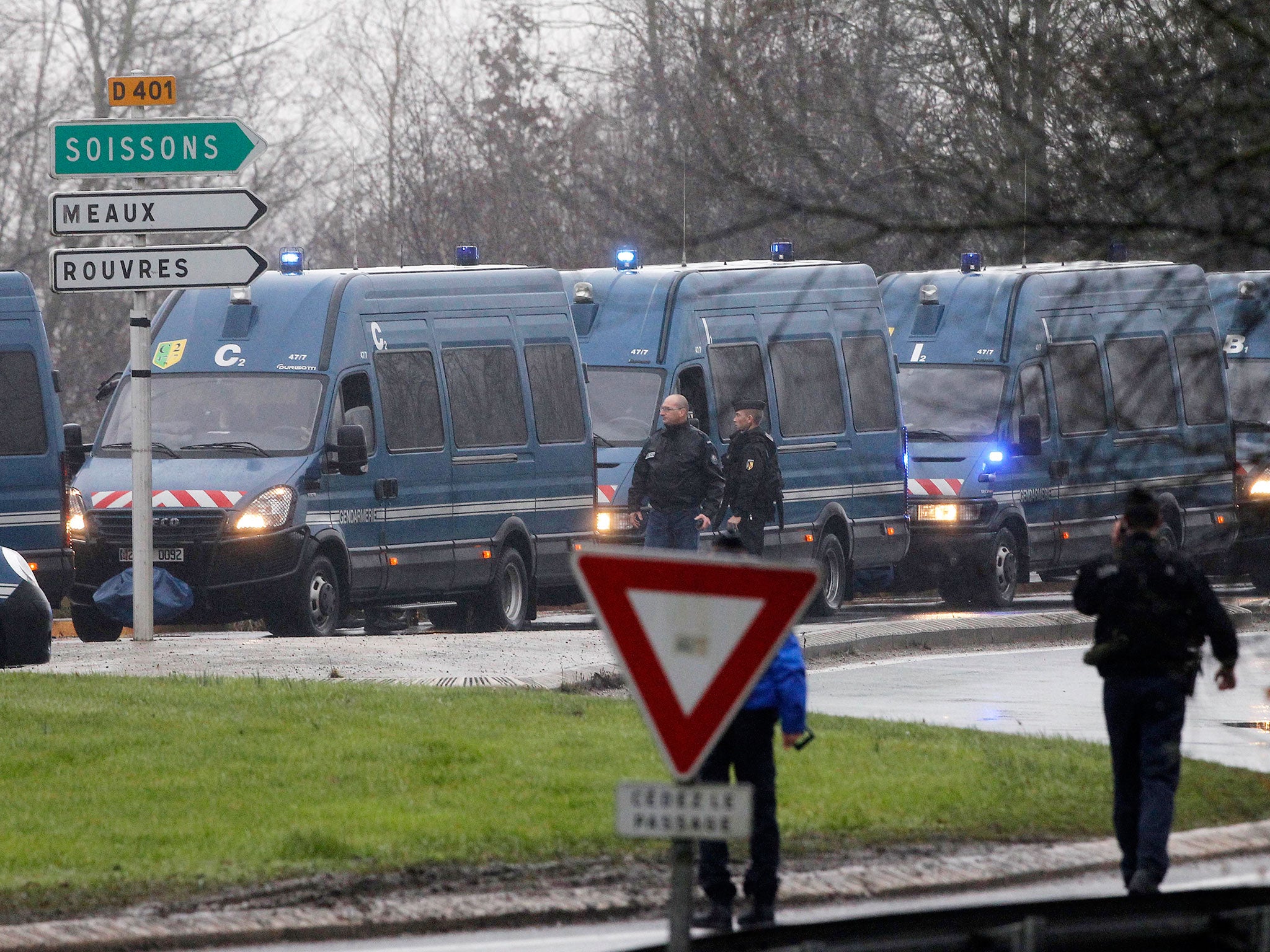 Police vans are lined up in Dammartin-en-Goele, northeast Paris, as part of an operation to seize two heavily armed suspects