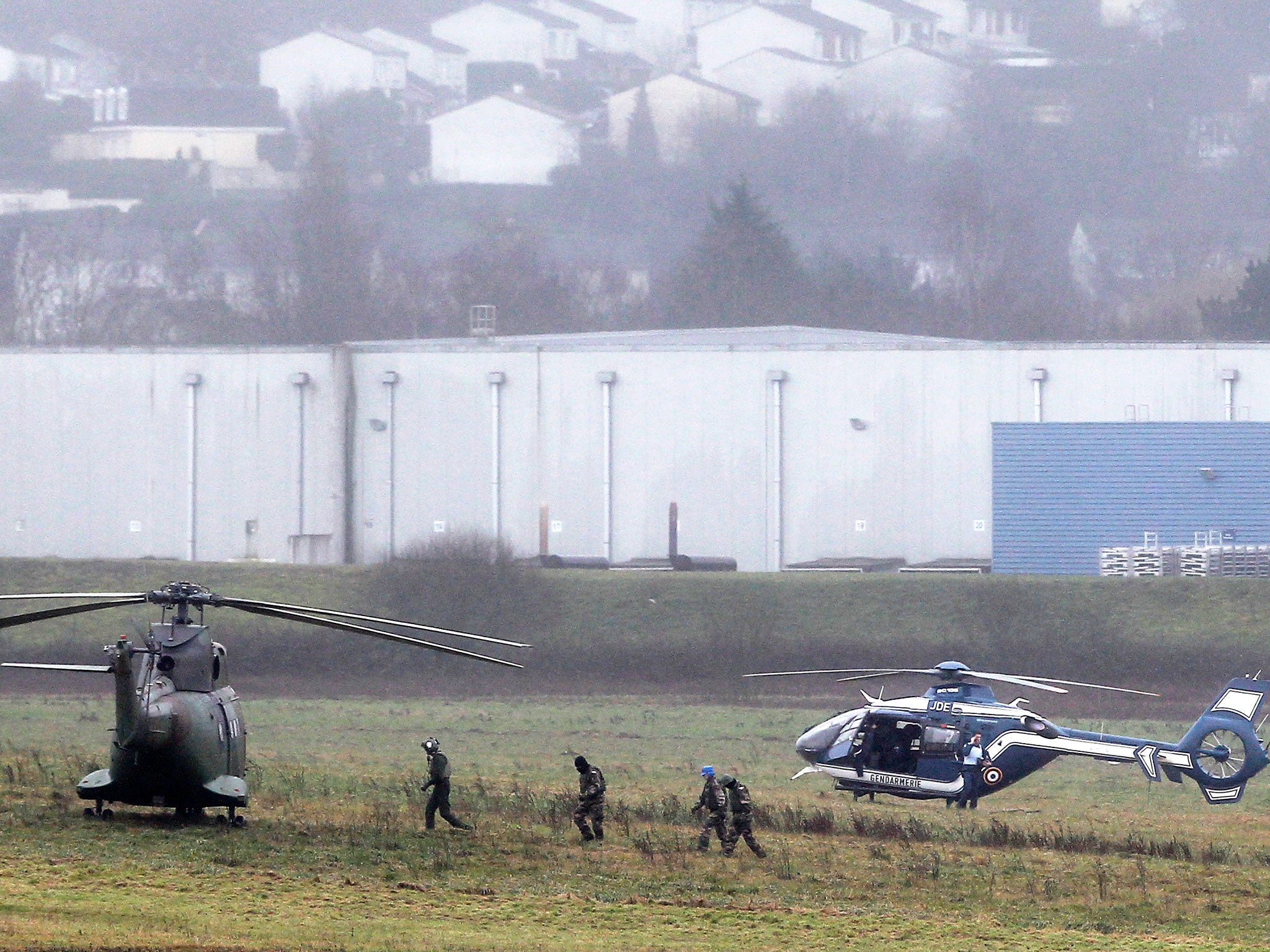 Police and army forces take positions in Dammartin-en-Goele, northeast Paris, as part of an operation to seize two heavily armed suspects