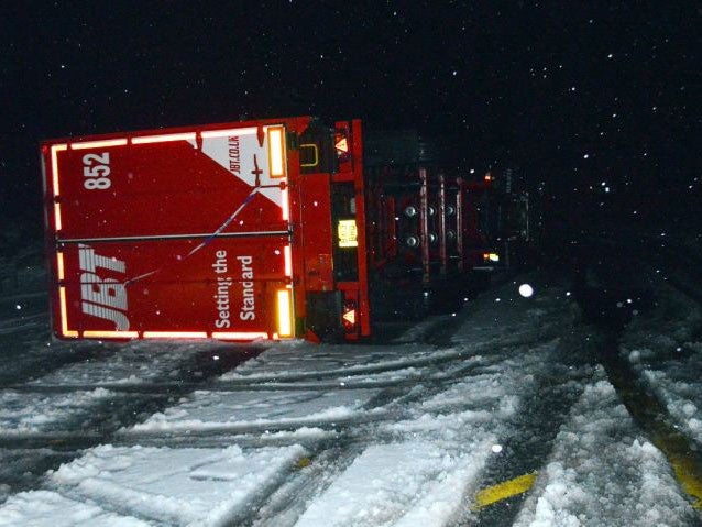An overturned lorry in snow on the A9 in Drumochter, Scottish Highlands, as more than 70,000 properties were left without power